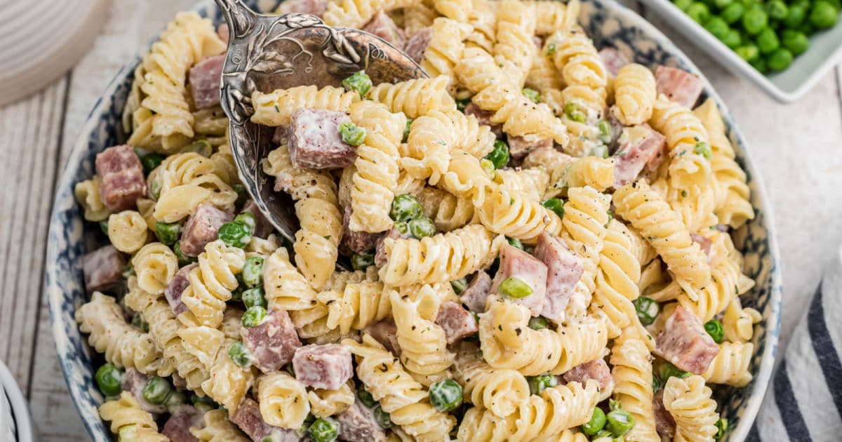 Close up of a bowl of Ruby Tuesday ham and pea pasta salad.