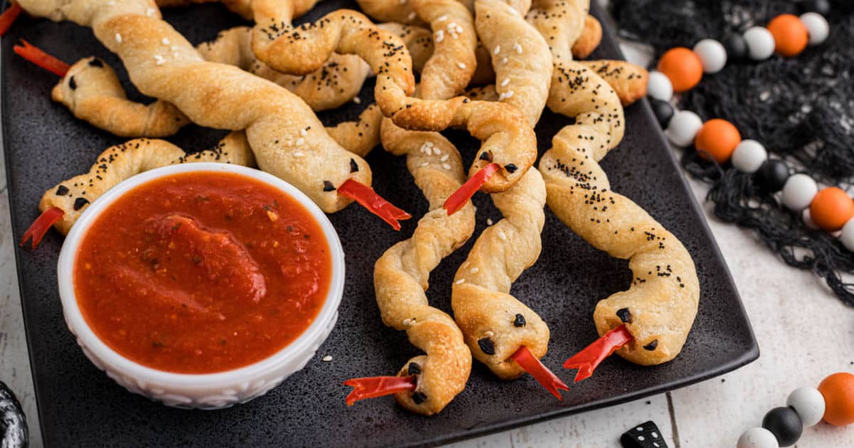 Breadstick rattlers on a plate with marinara sauce.