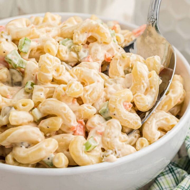 Close up of a bowl of KFC Macaroni Salad with a spoon digging in.