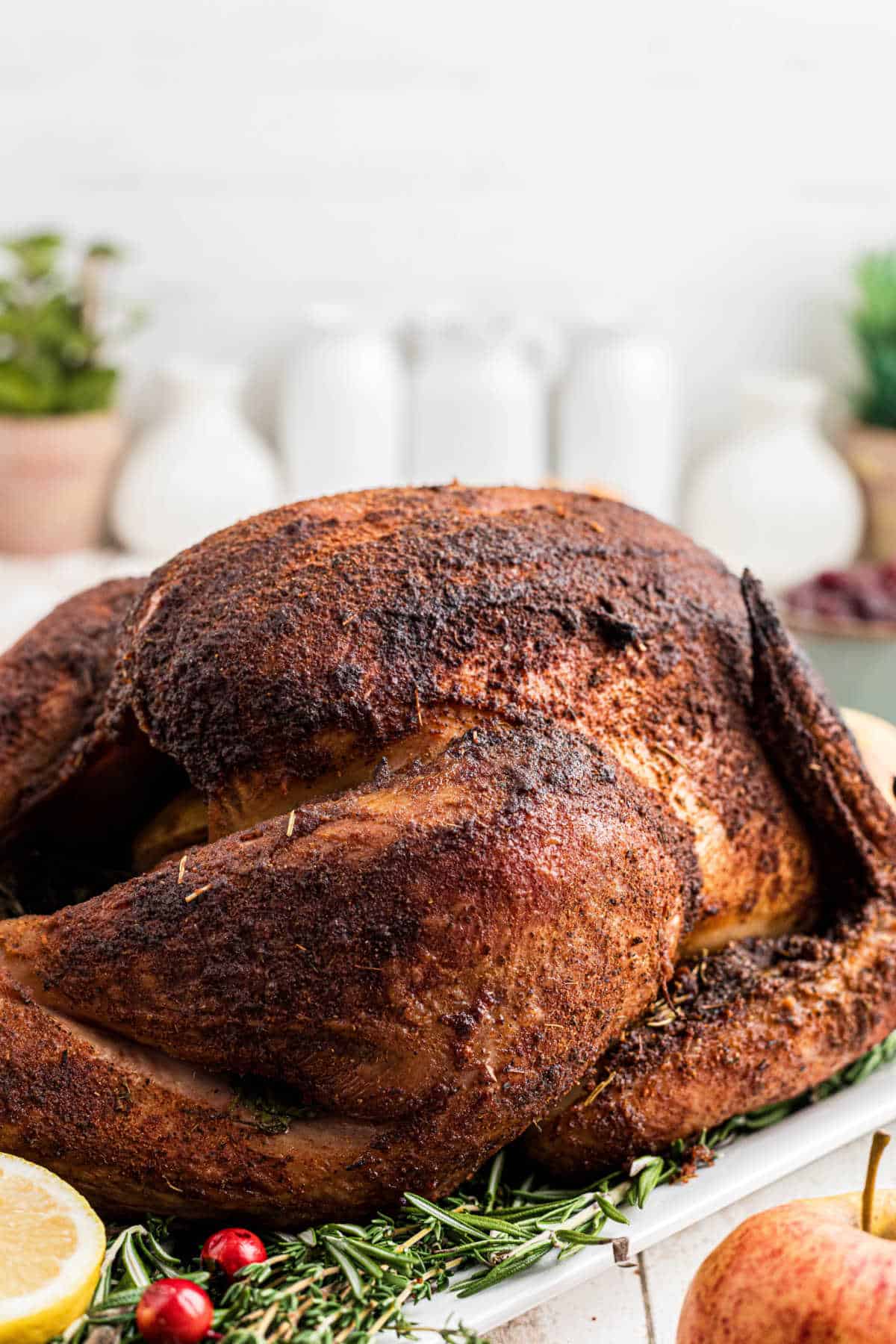 A whole turkey from the side, that has been cooked with a smoked turkey injection recipe.