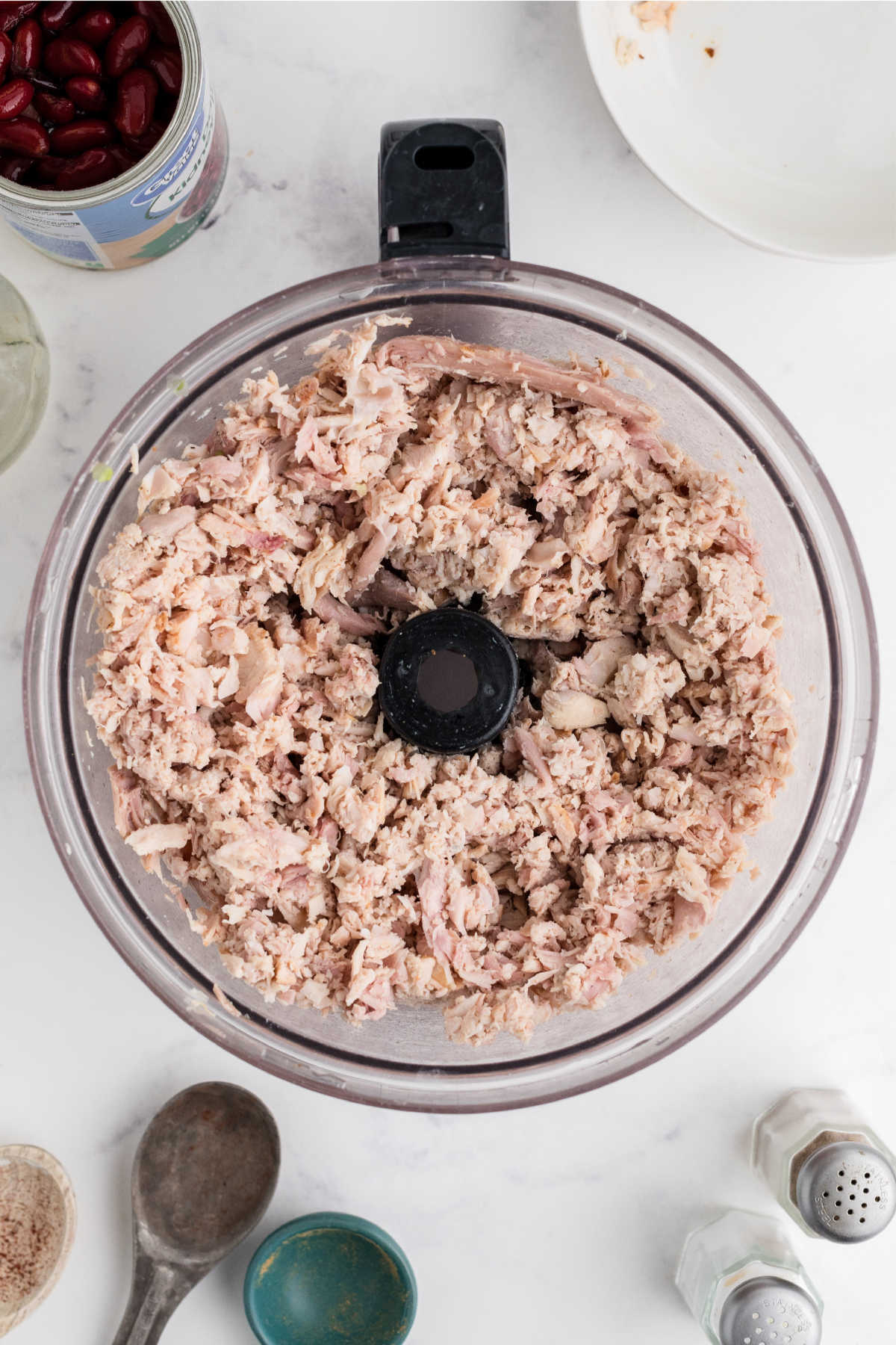 Turkey added to a food processor and chopped up.