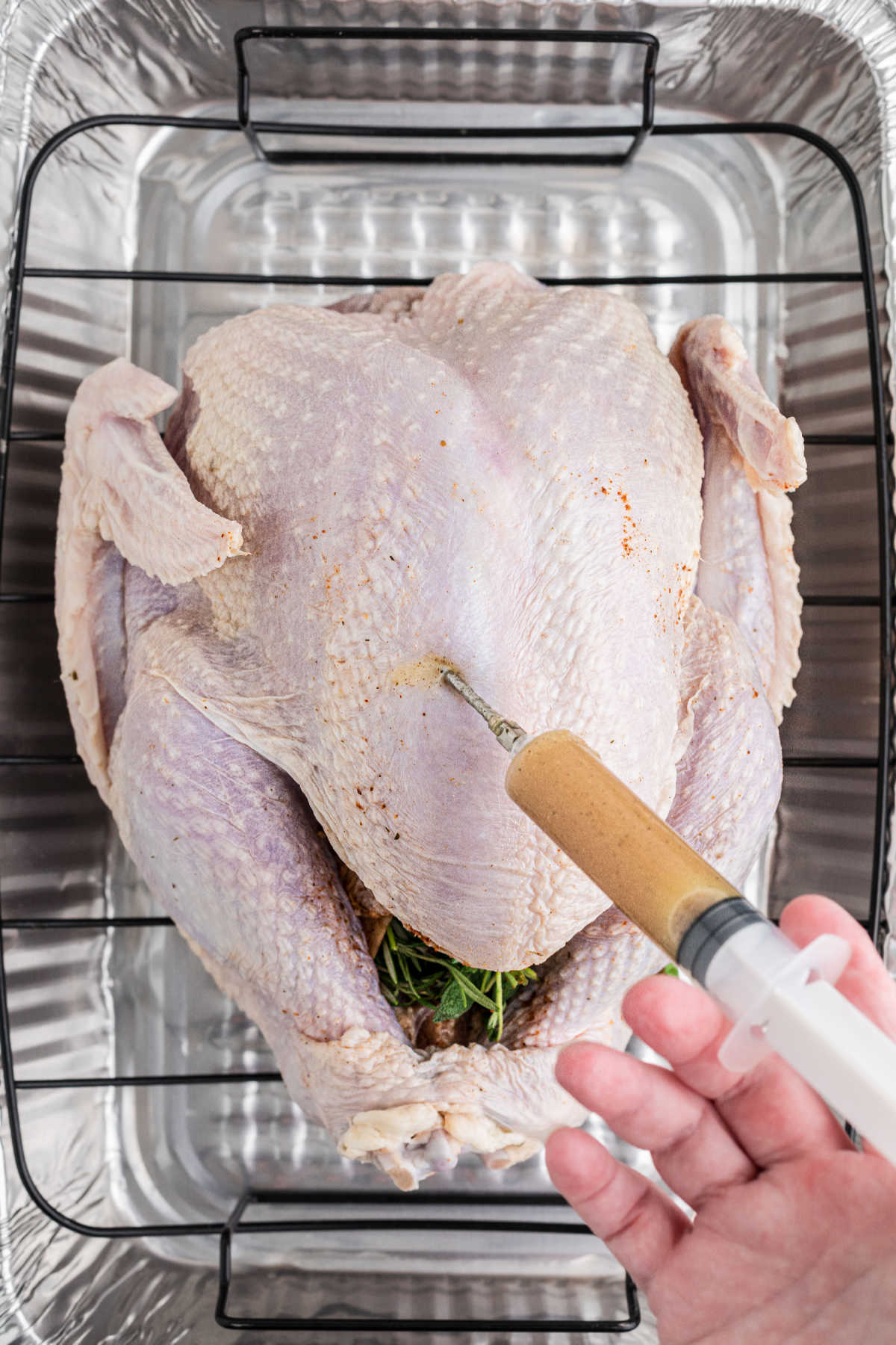 A turkey being injected with a marinade.