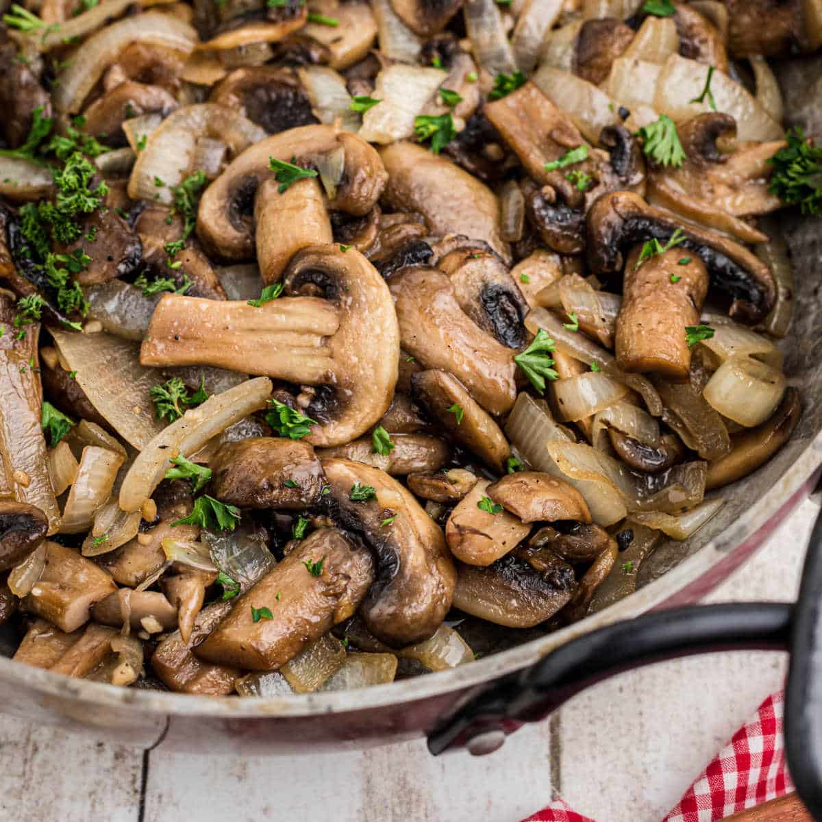 Close up of a skillet with Texas Roadhouse Sauteed Mushrooms inside.