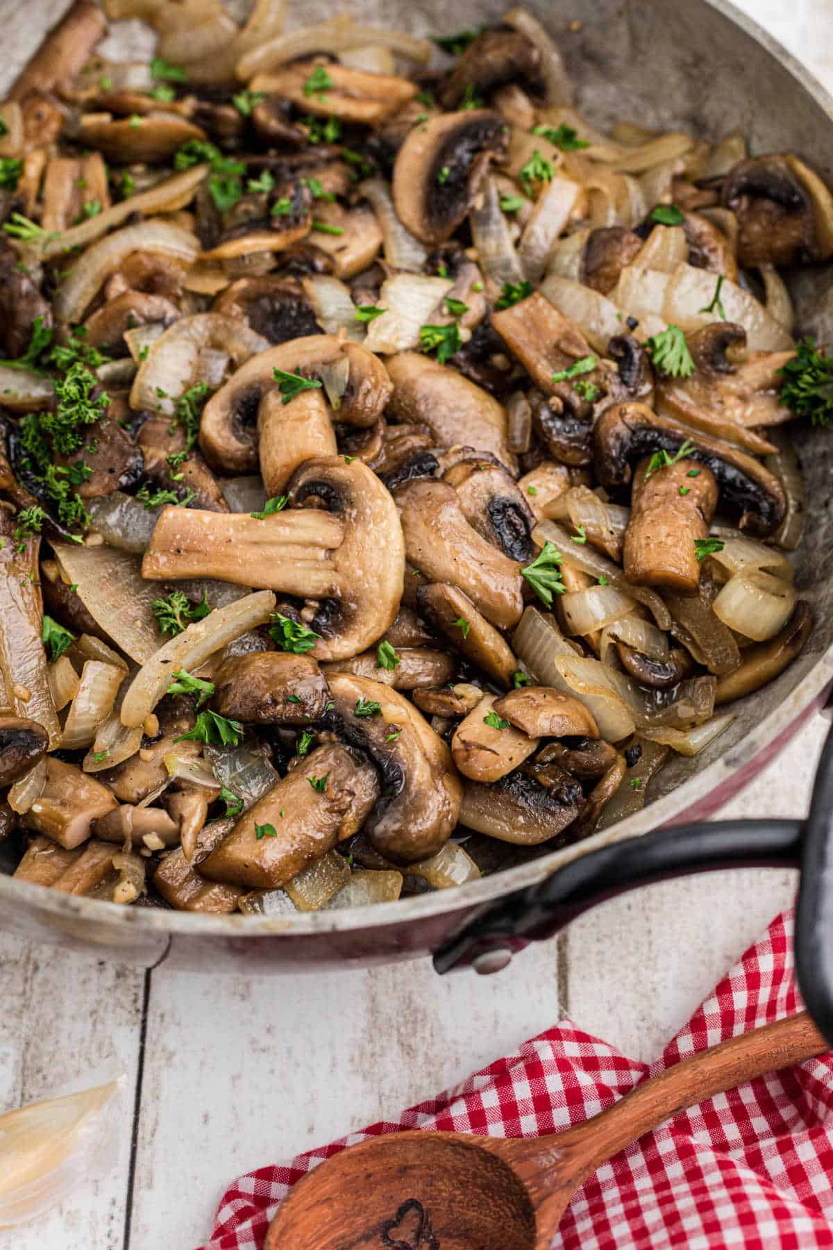 Side shot of a skillet with Texas Roadhouse Sauteed Mushrooms inside.