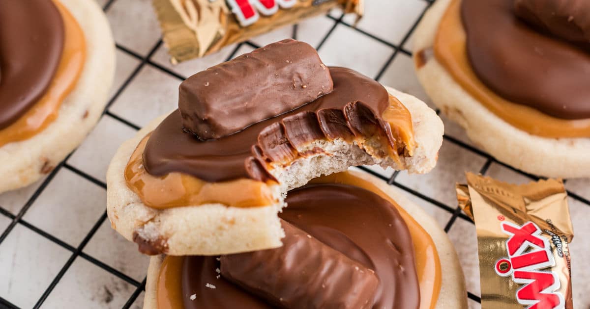 Close up of a copycat Crumbl Twix Cookies, with a bite taken out.