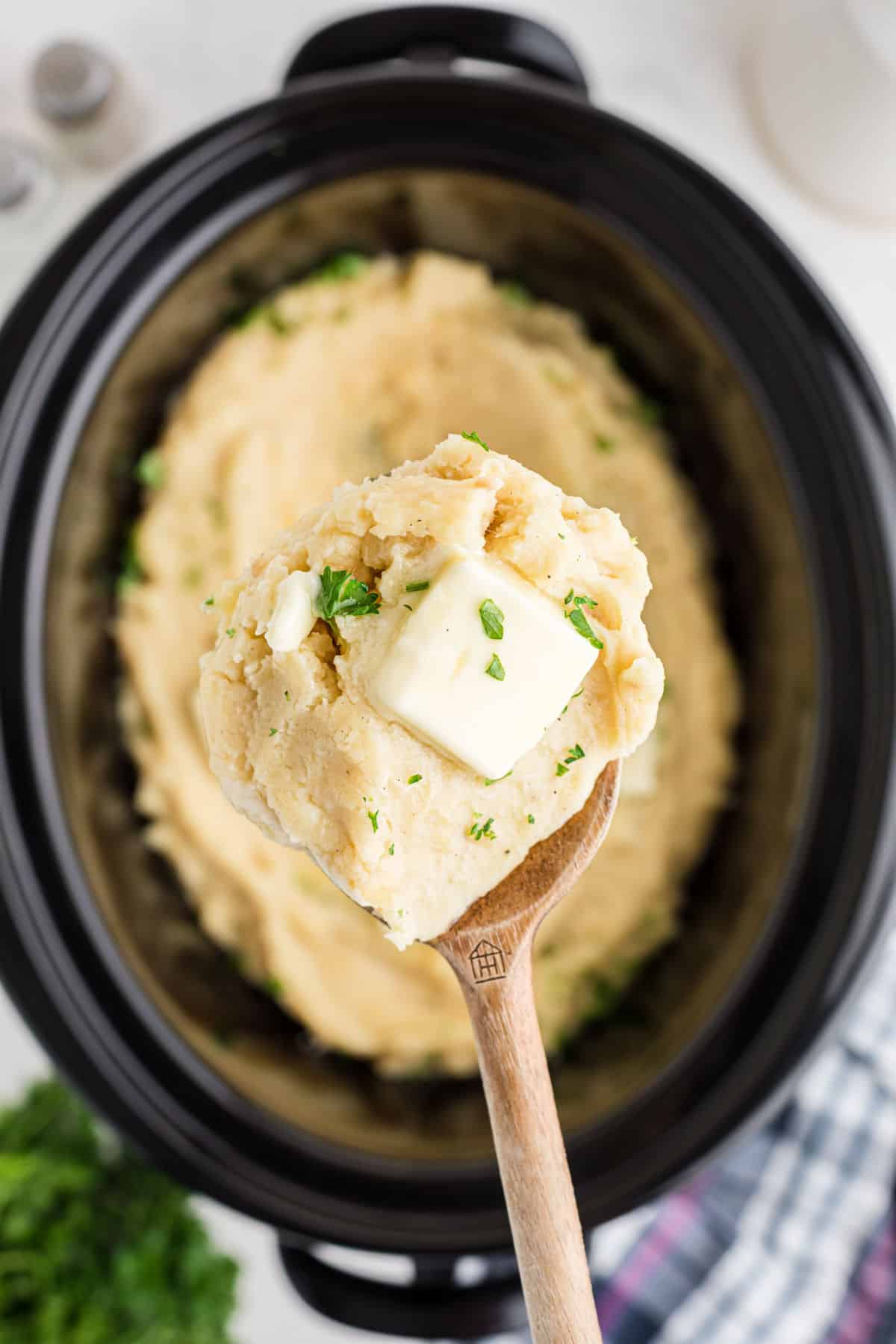 Crock Pot Mashed Potatoes, a spoon scooping some out.