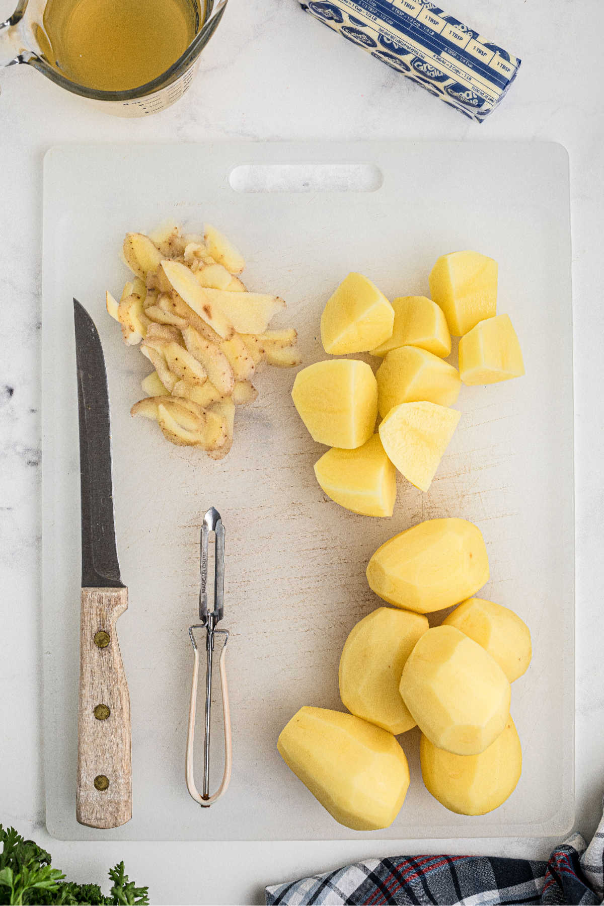 Potatoes being peeled and chopped.