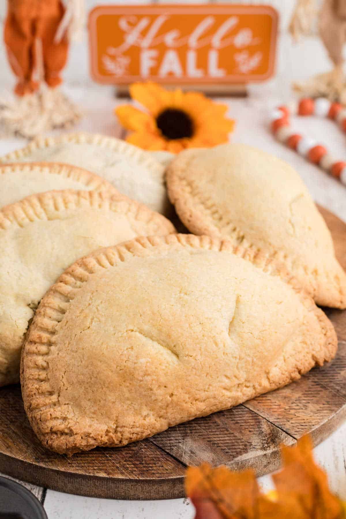 Sweet Potato Hand Pies on a board with fall decor.