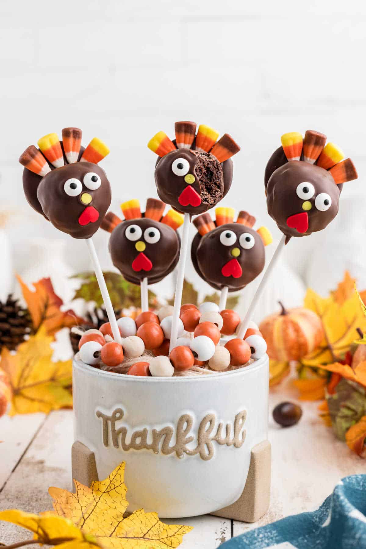 A thanksgiving cake pop recipe, one showing a bite taken out.