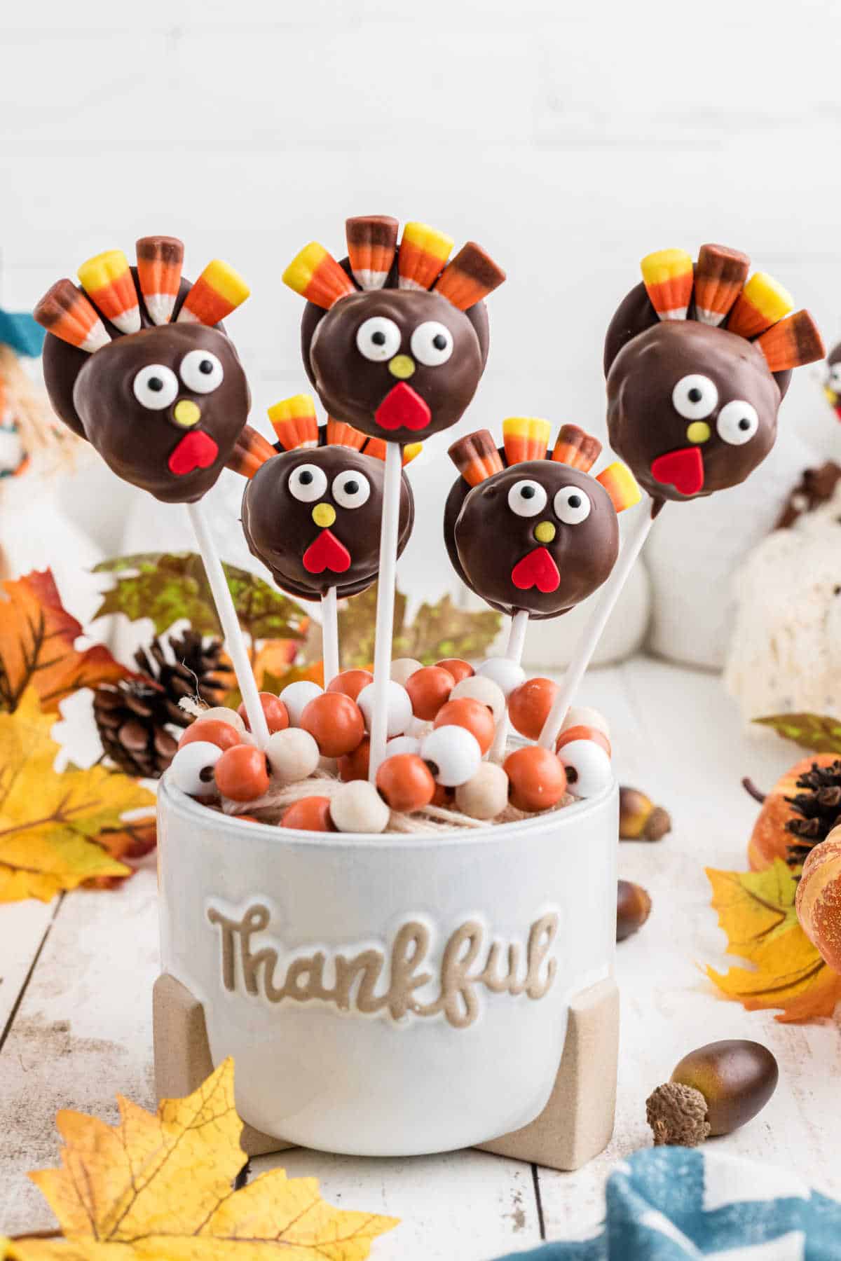 A thanksgiving cake pop recipe, with cake pops sitting in a Thankful vase.