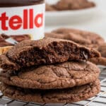 Close up of some nutella brownie cookies, one broken in half. Text overlay added for Pinterest.