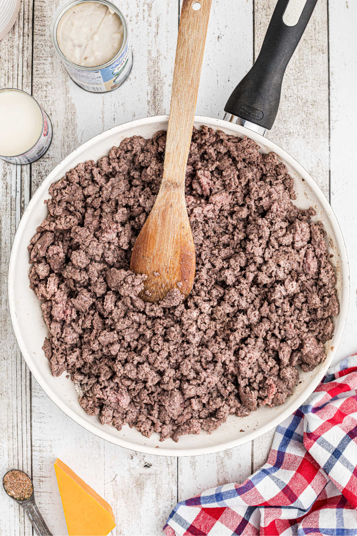 Ground beef being browned in a large skillet.