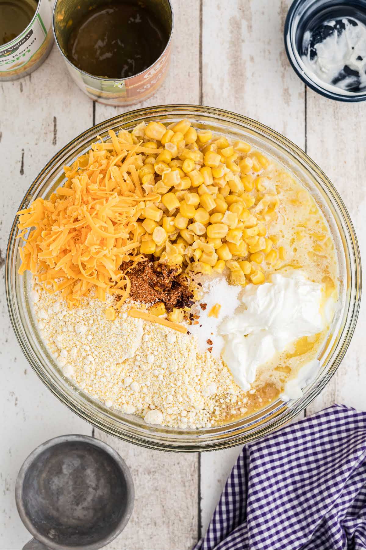 A large mixing bowl with corn casserole ingredients ready to be mixed together.