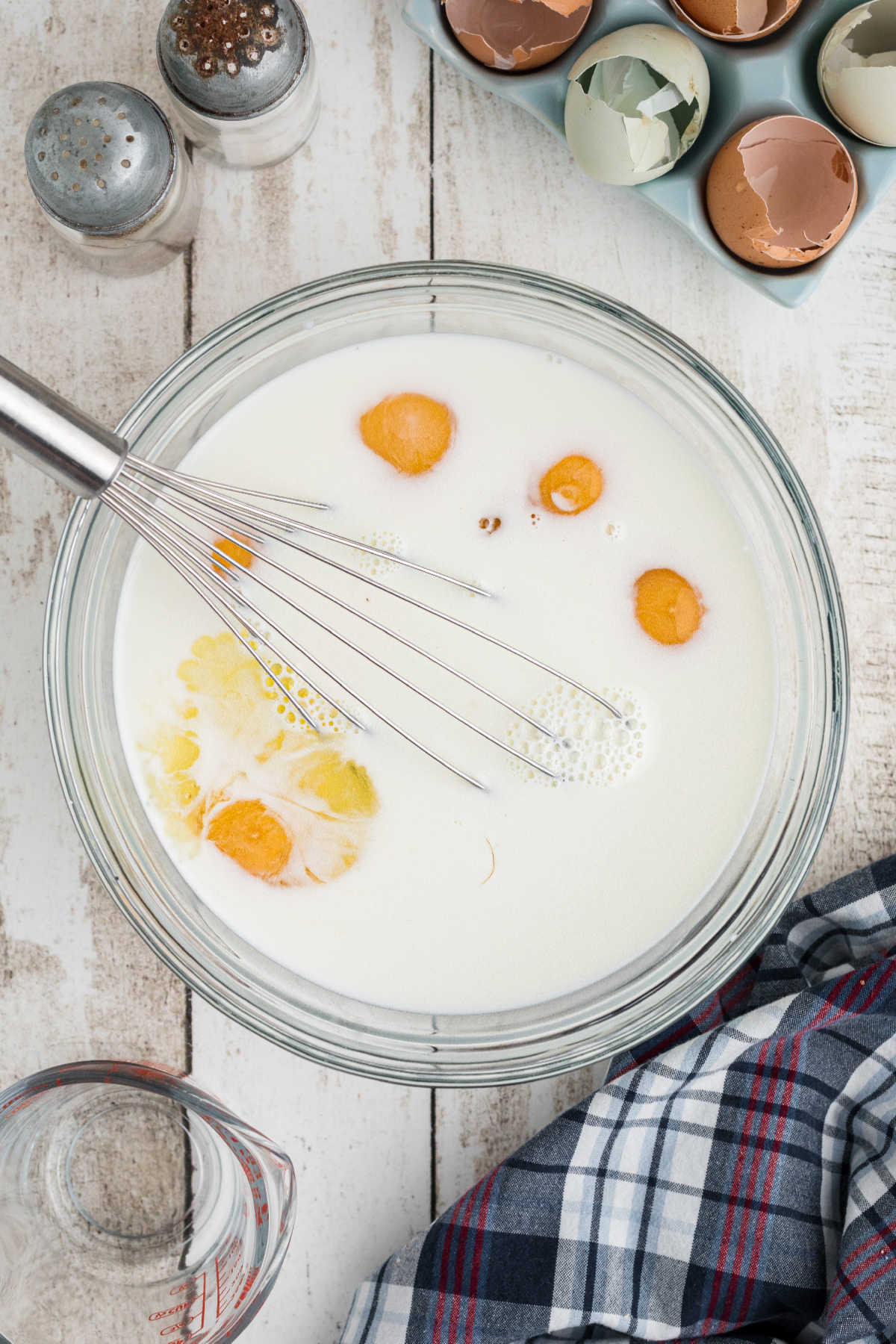 Eggs and milk being beaten together in a bowl.