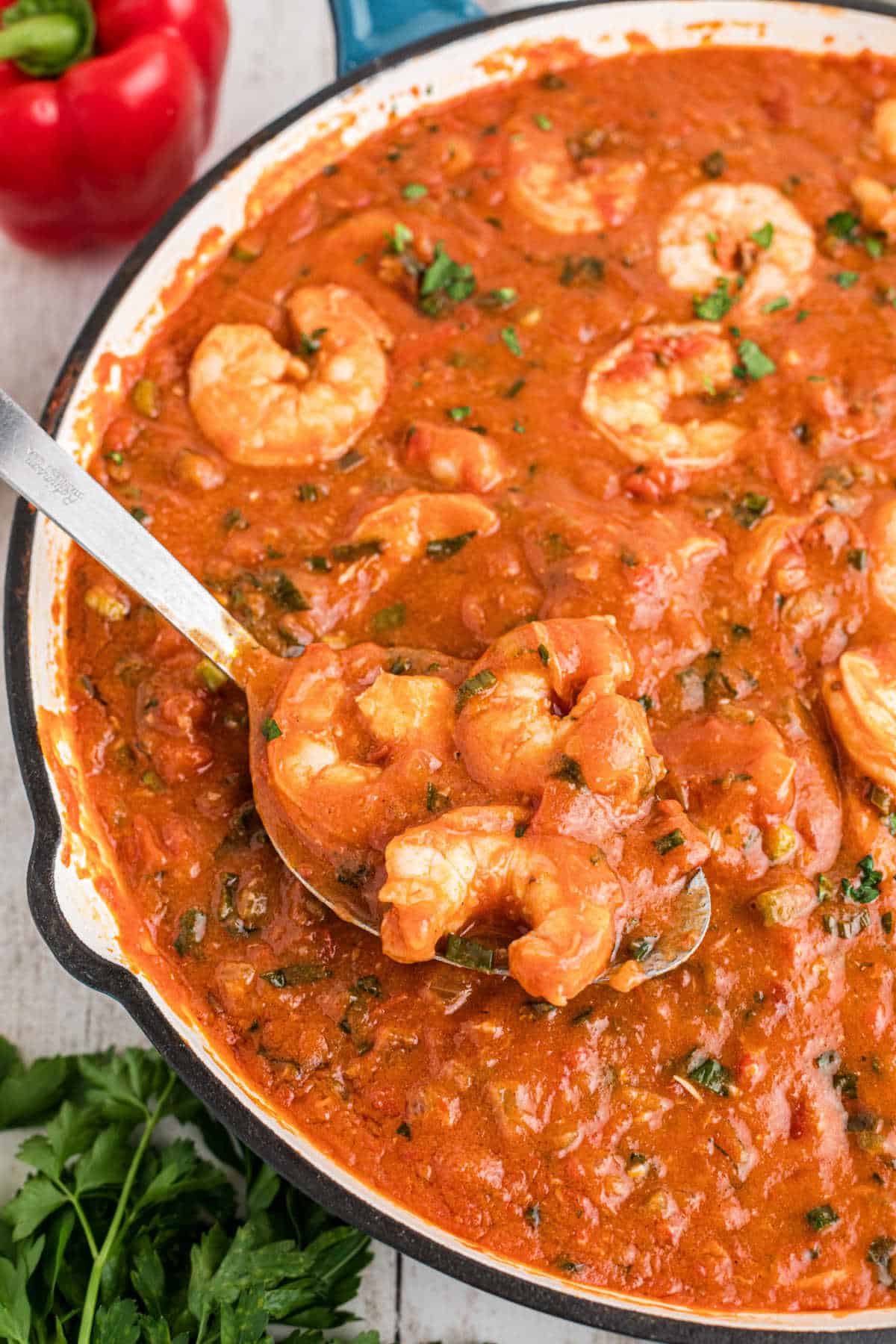 New Orleans Shrimp Creole in a large skillet with a spoon dishing up.