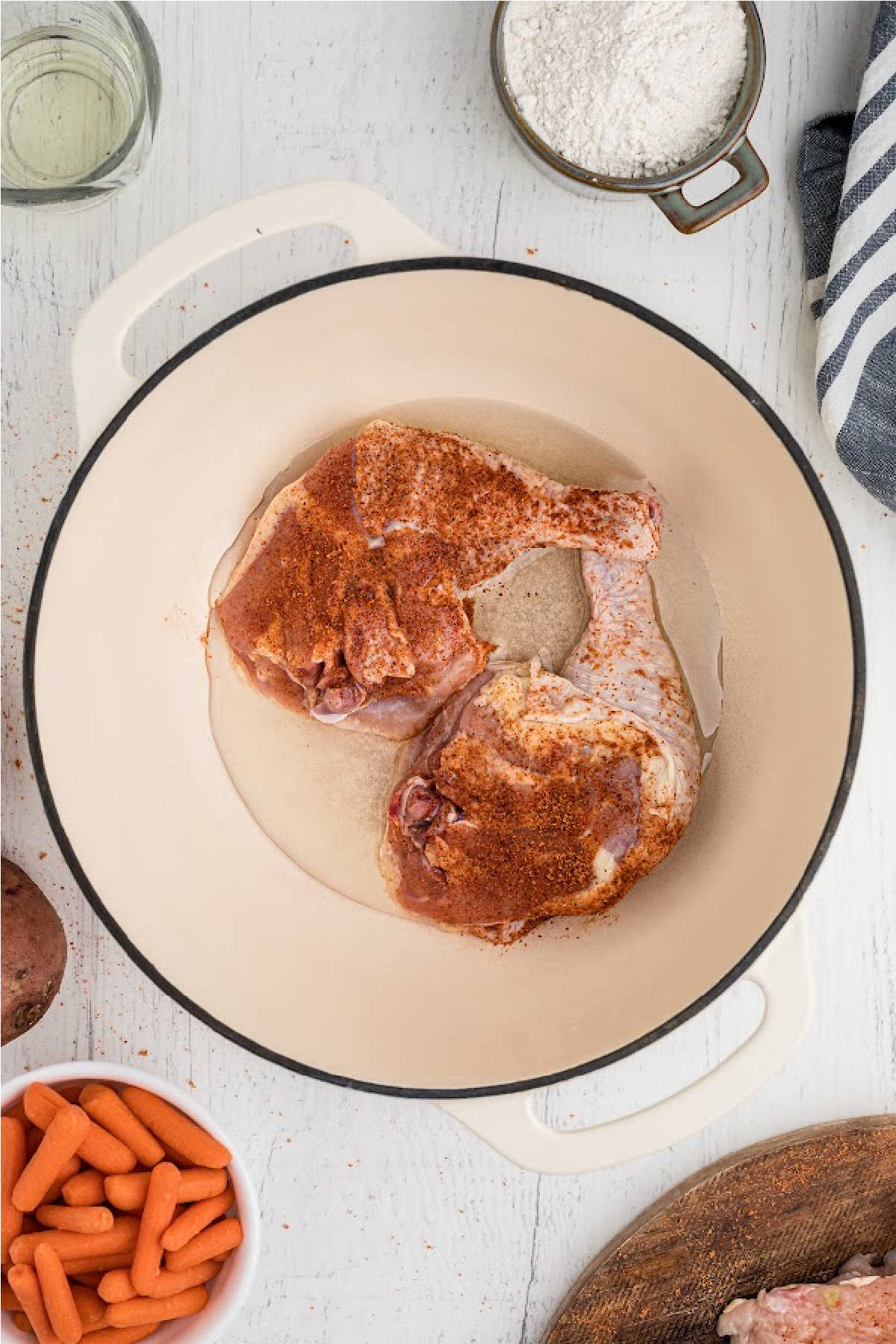 Oil in a pot, with some chicken pieces.