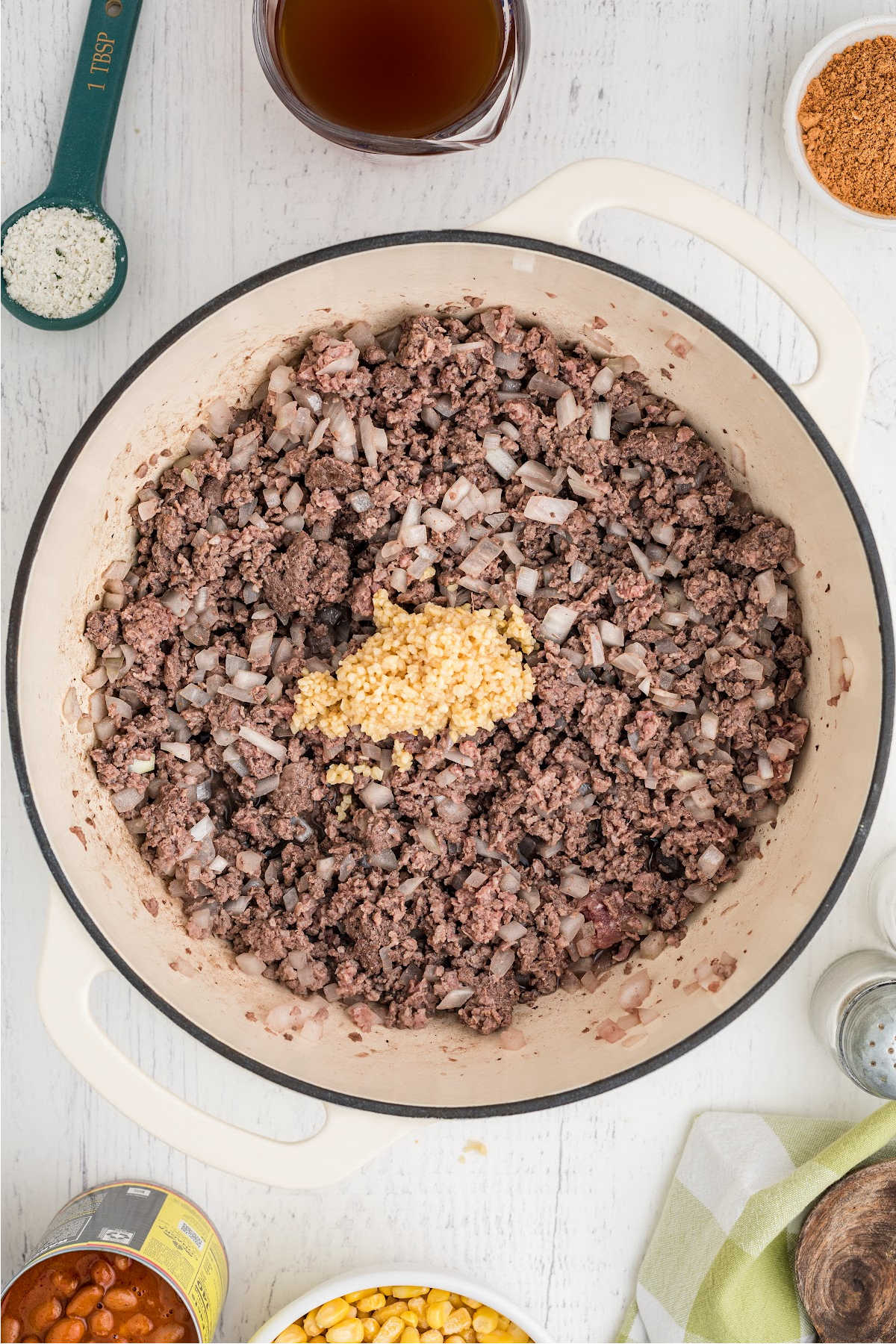 Garlic added to a pot of browned ground beef and onions.