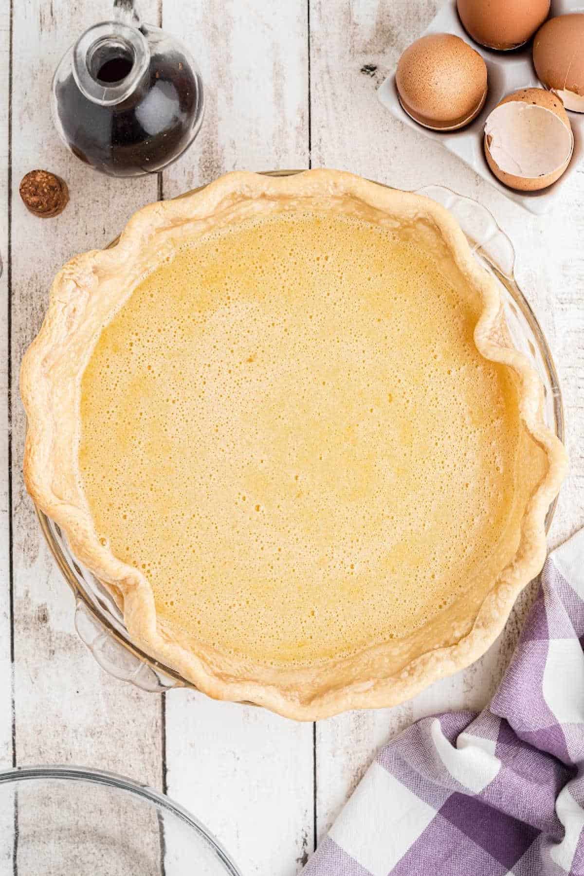 A pie crust filled, ready to be baked.