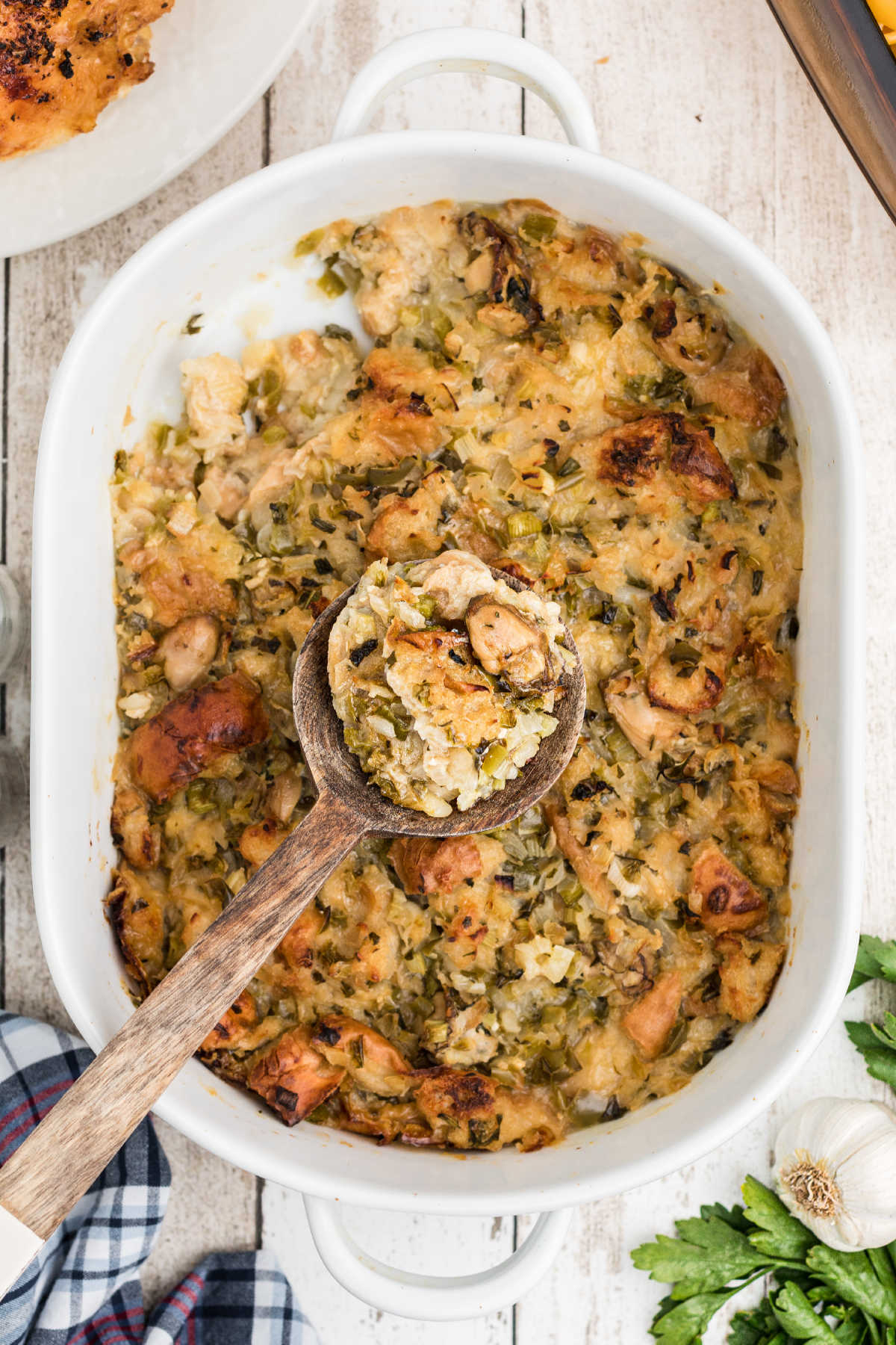 Baked Oyster Dressing with a spoon digging into it.
