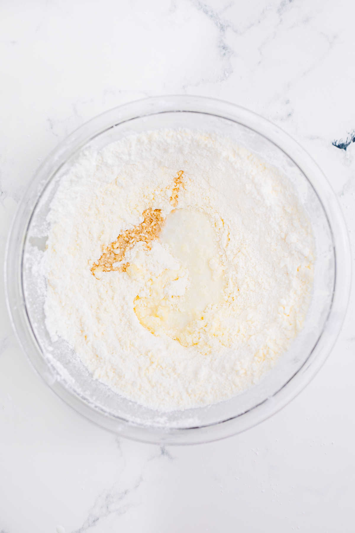 A mixing bowl with frosting being mixed.