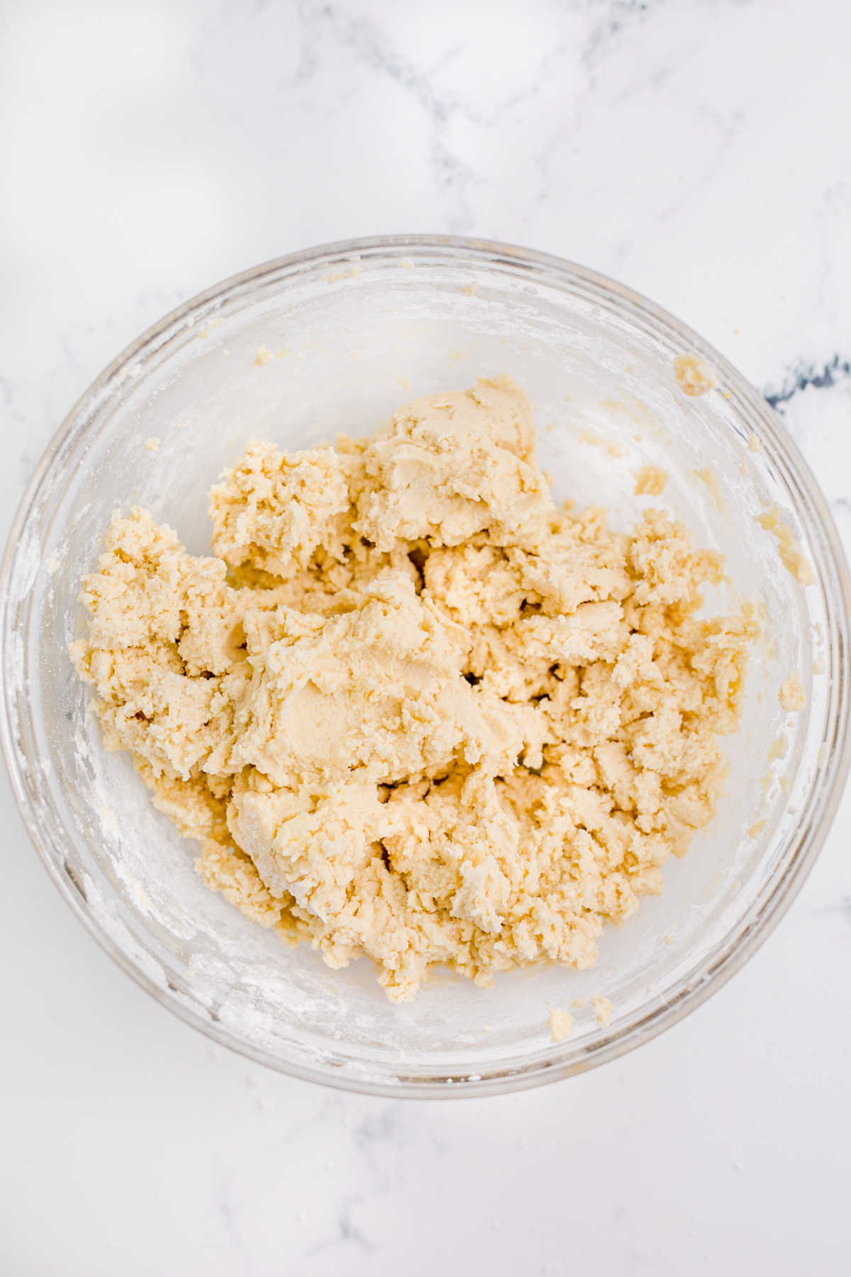 A mixing bowl with some sugar cookie dough.