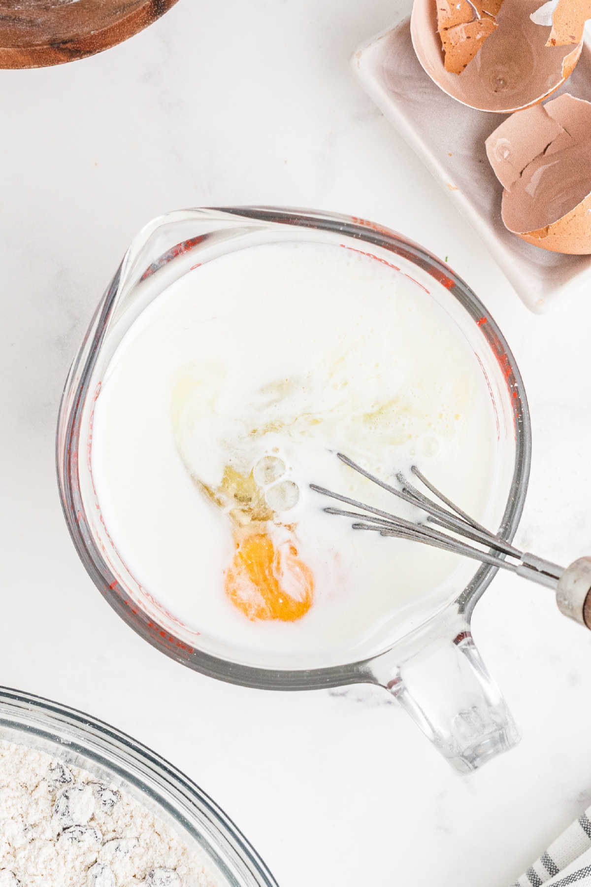 Eggs being beaten into buttermilk.