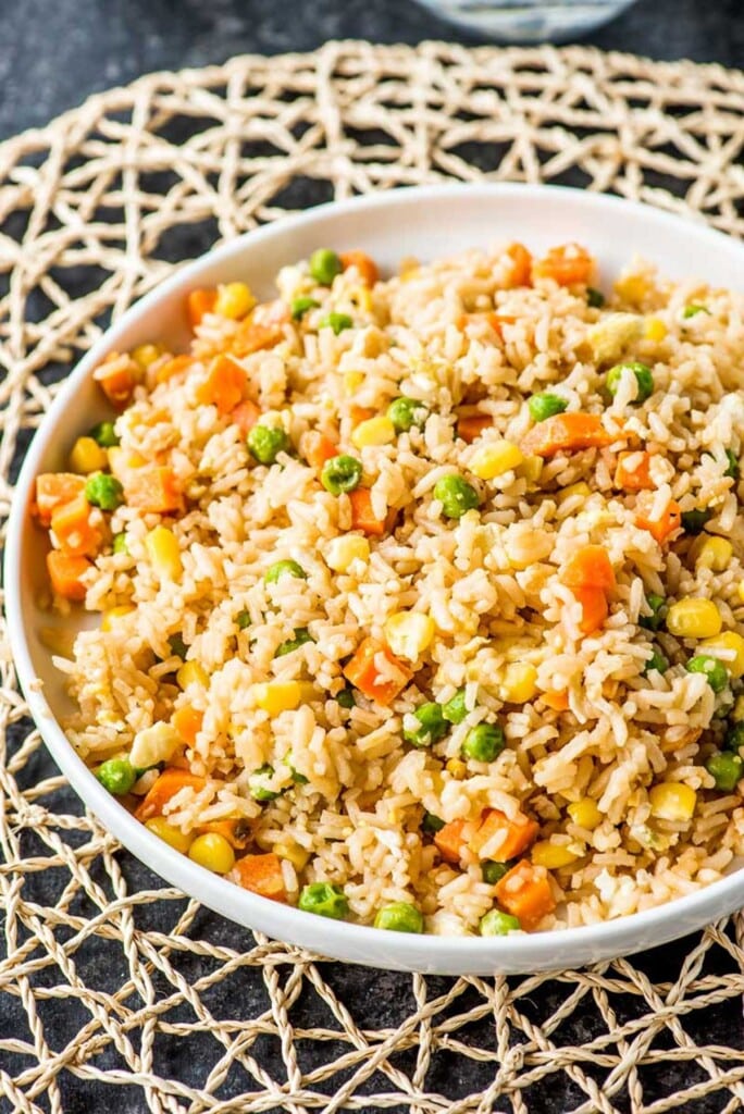 A bowl full of fried rice with veggies.