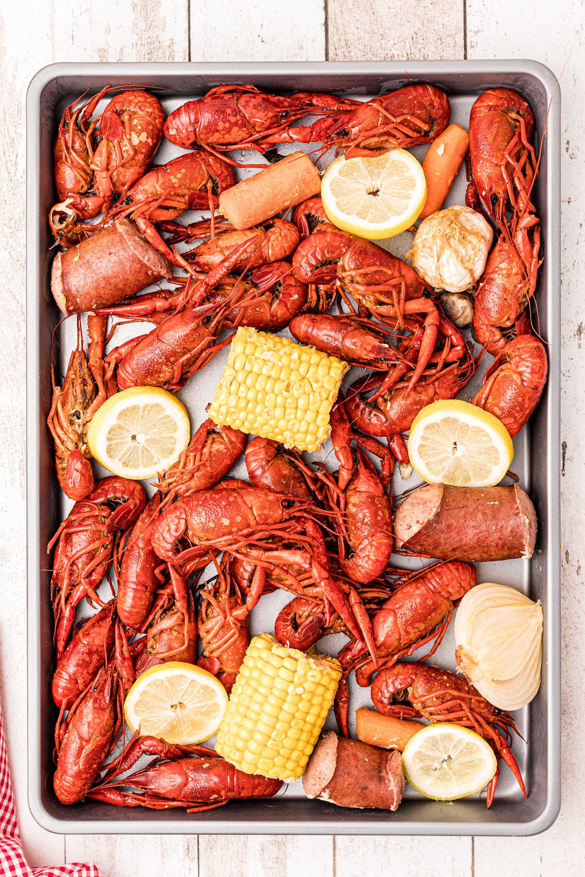 A platter filled with boiled crawfish and vegetables.