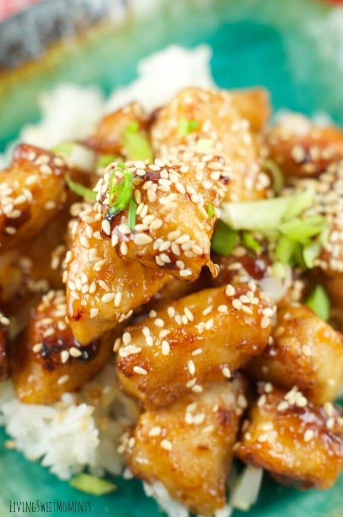 Close up of some honey sesame chicken, with sesame seeds sprinkled all over.