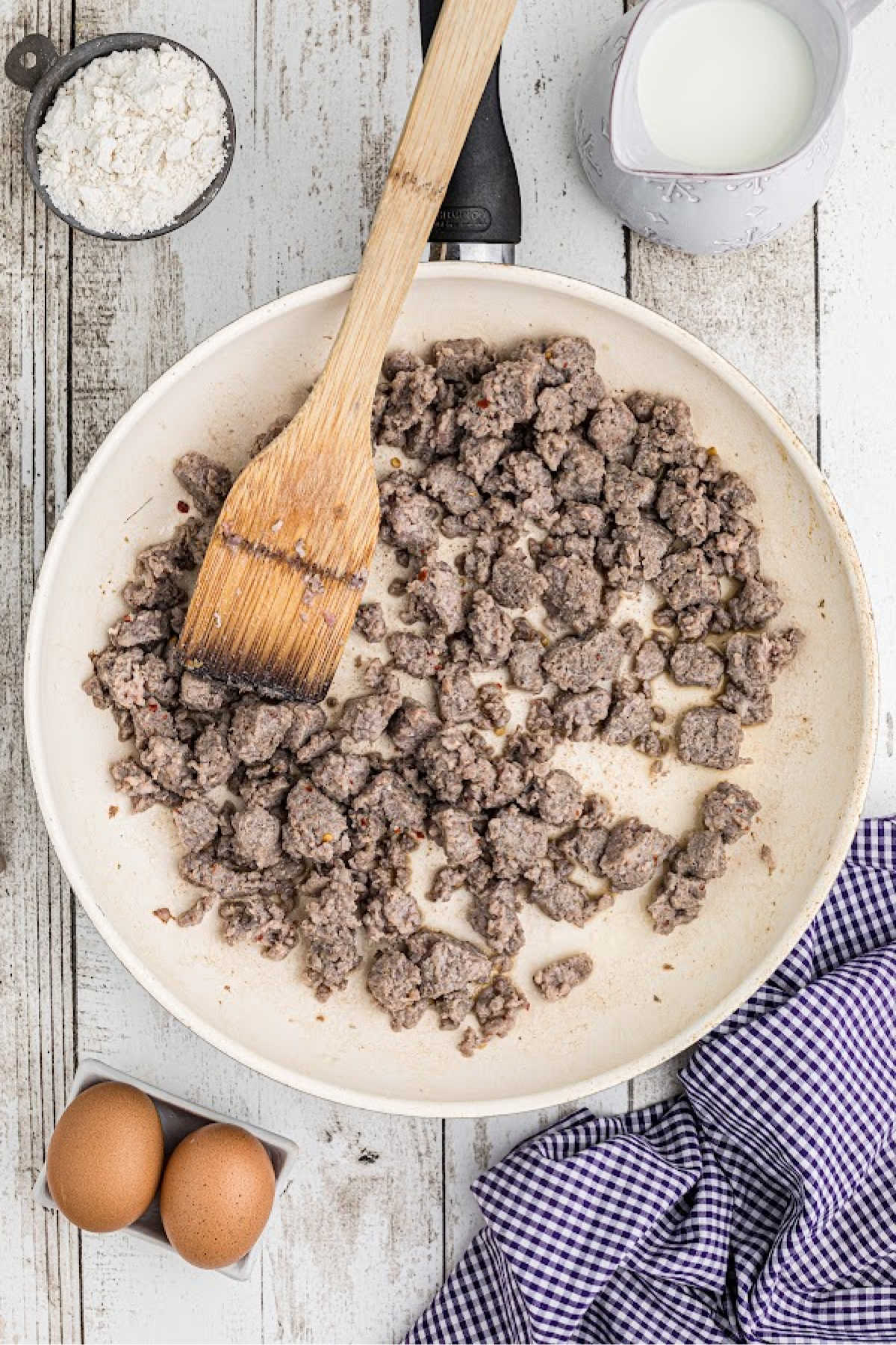 Ground breakfast sausage in a skillet browning.