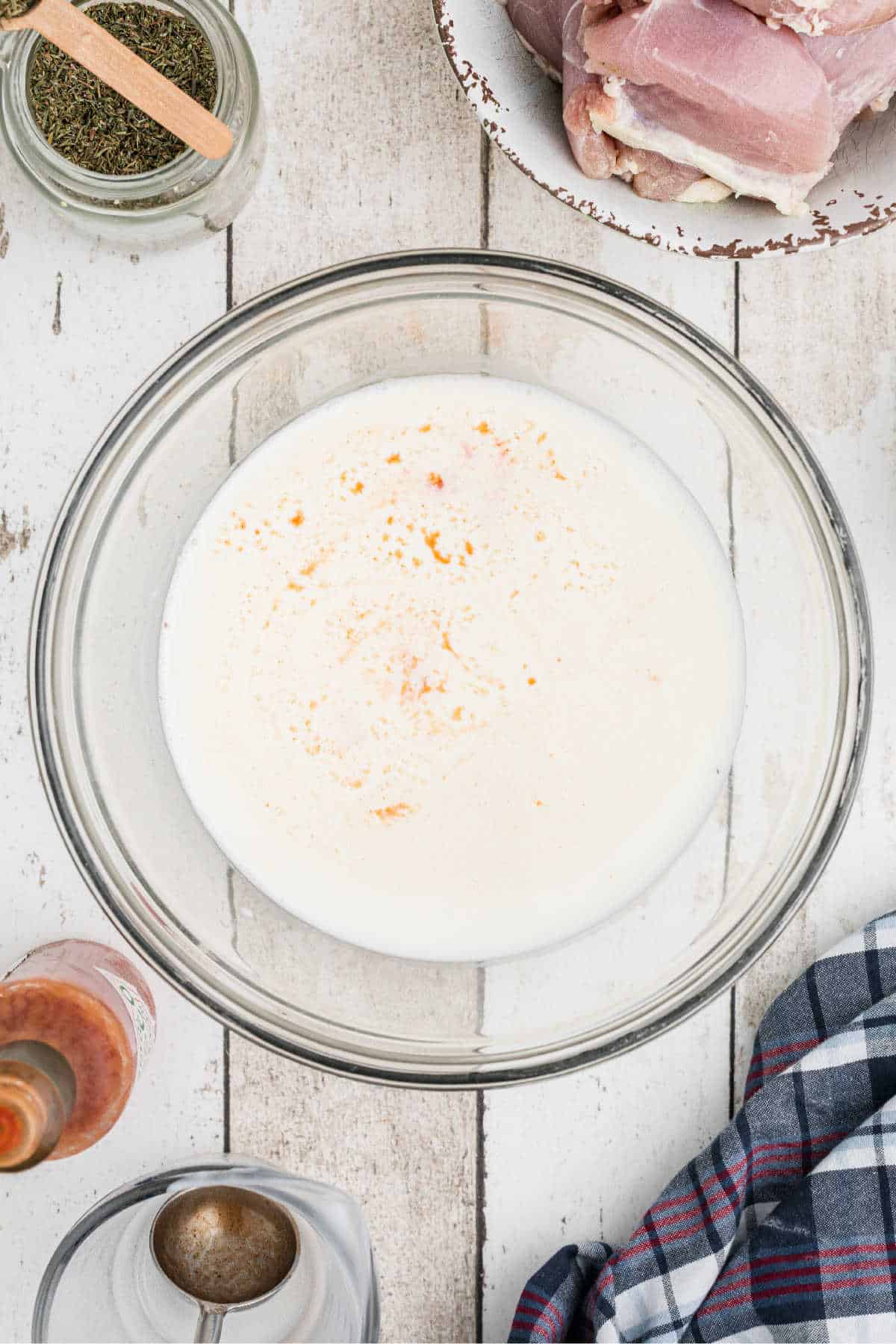 A large mixing bowl filled with buttermilk and other ingredients.