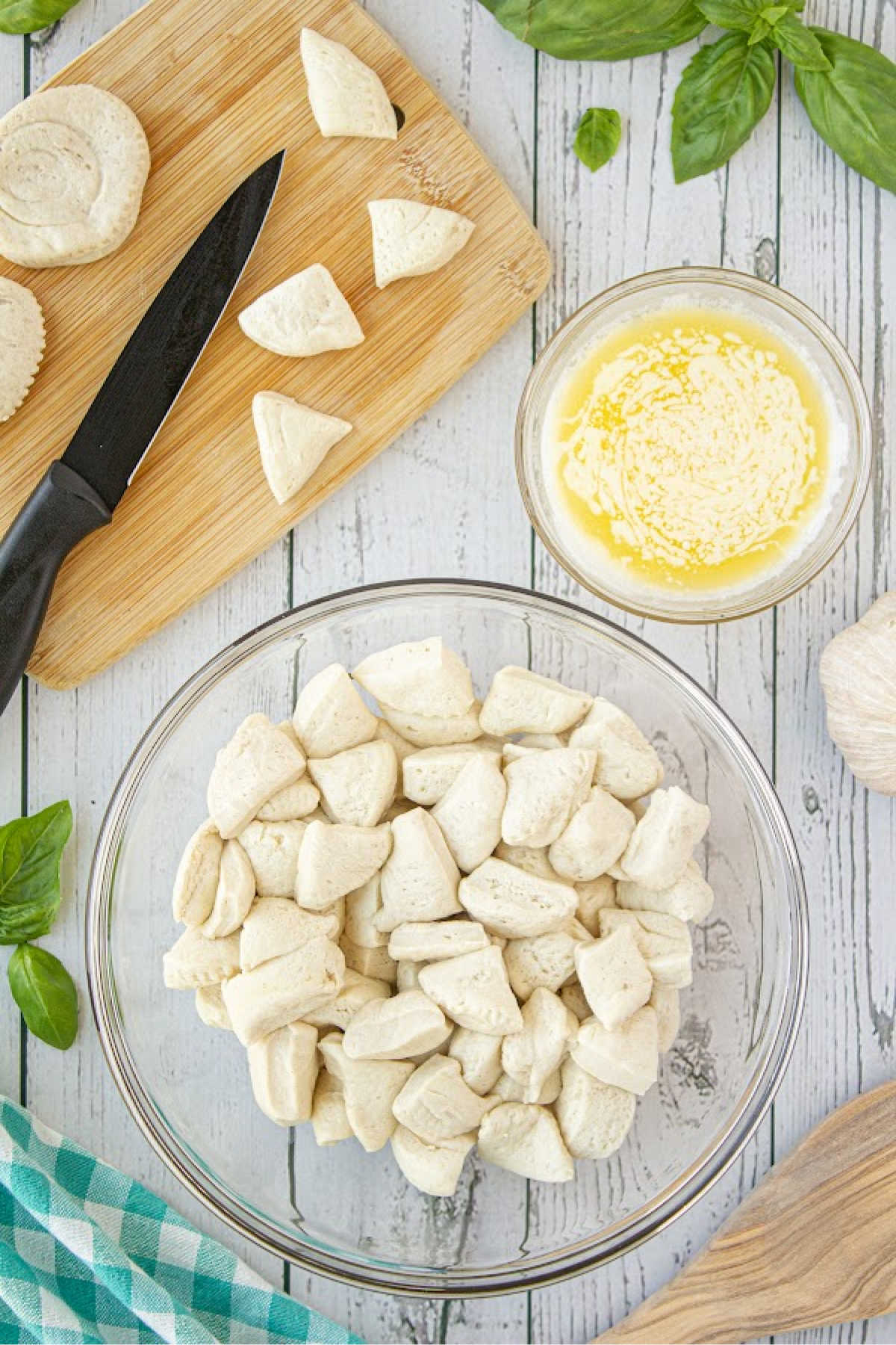A bowl full of cut refrigerated biscuits.