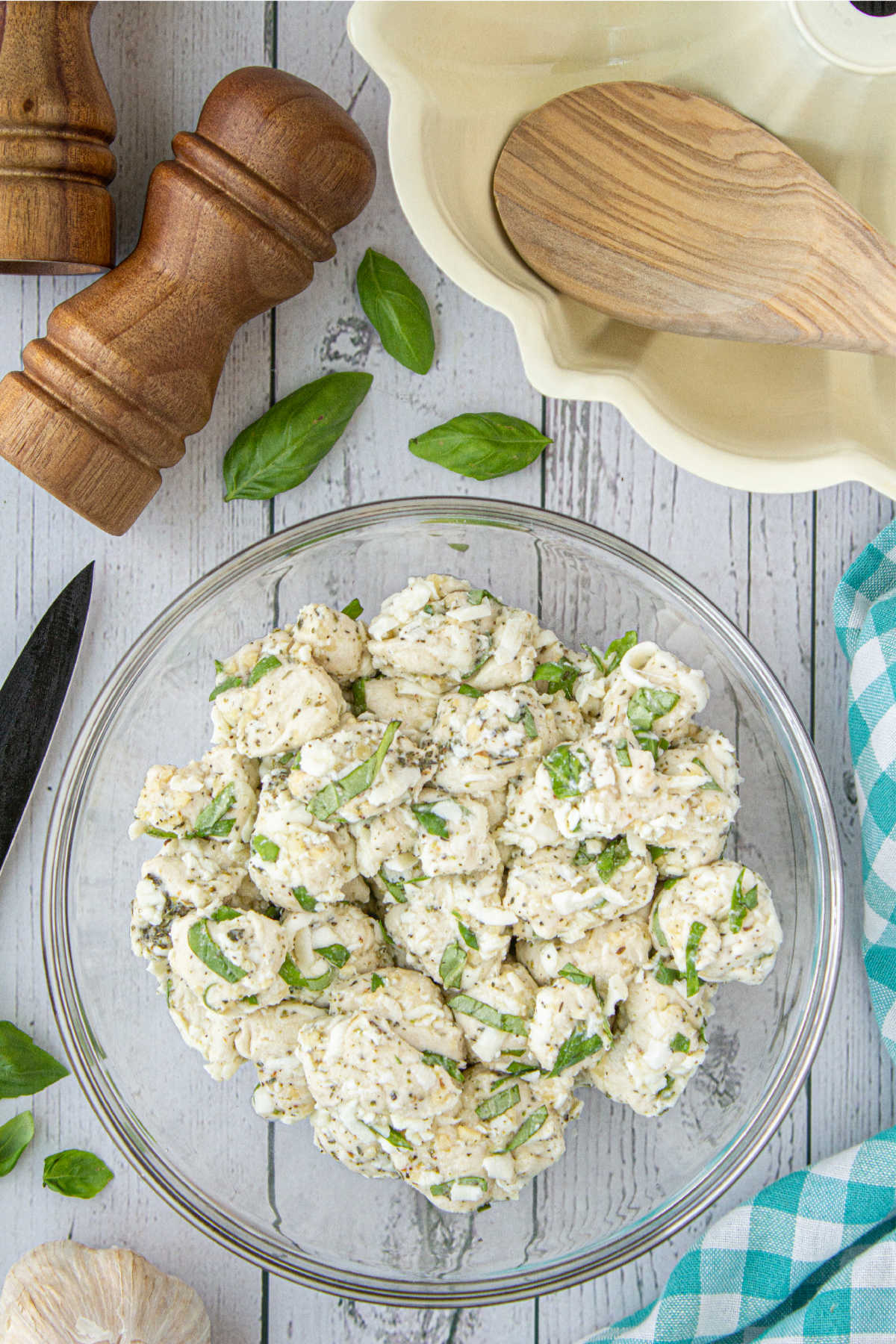 A large mixing bowl with mixed up biscuit dough and seasonings.