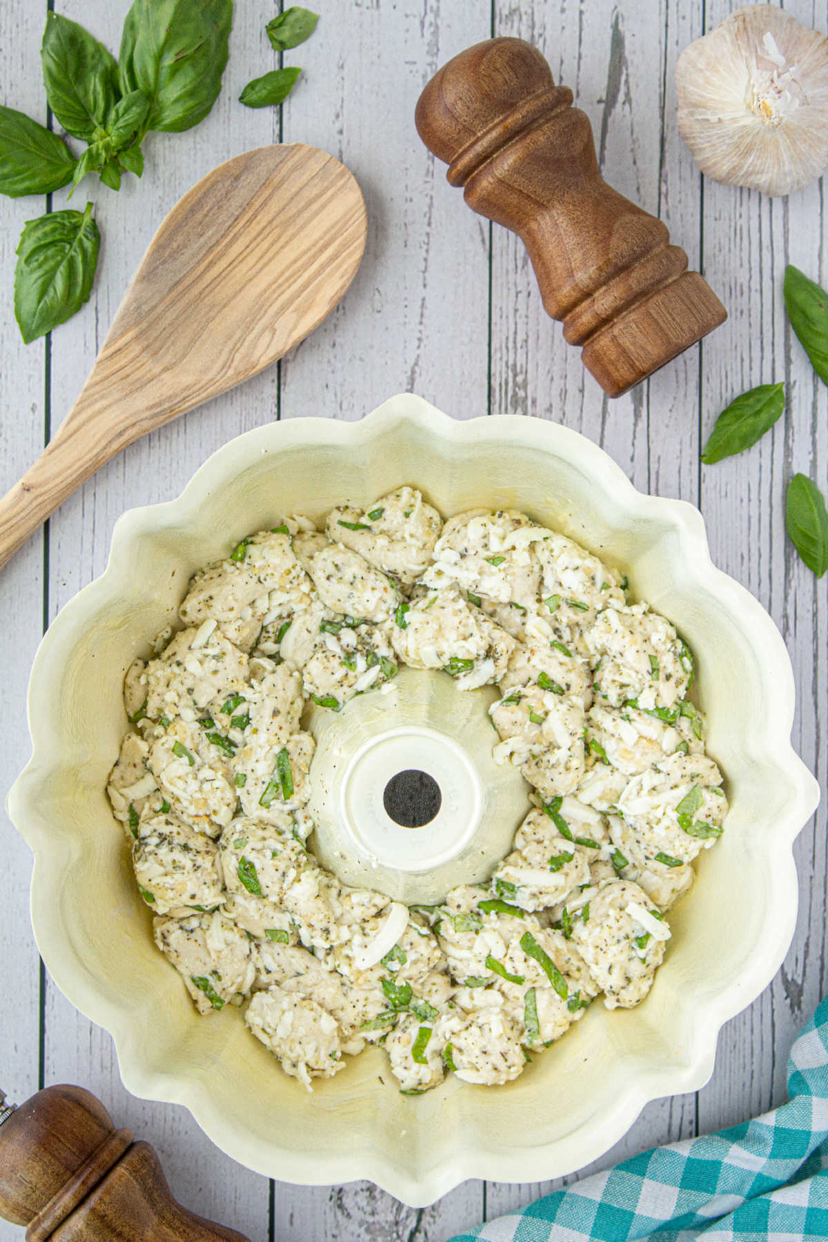A bundt pan filled with refrigerated biscuit dough, cheese and seasonings.