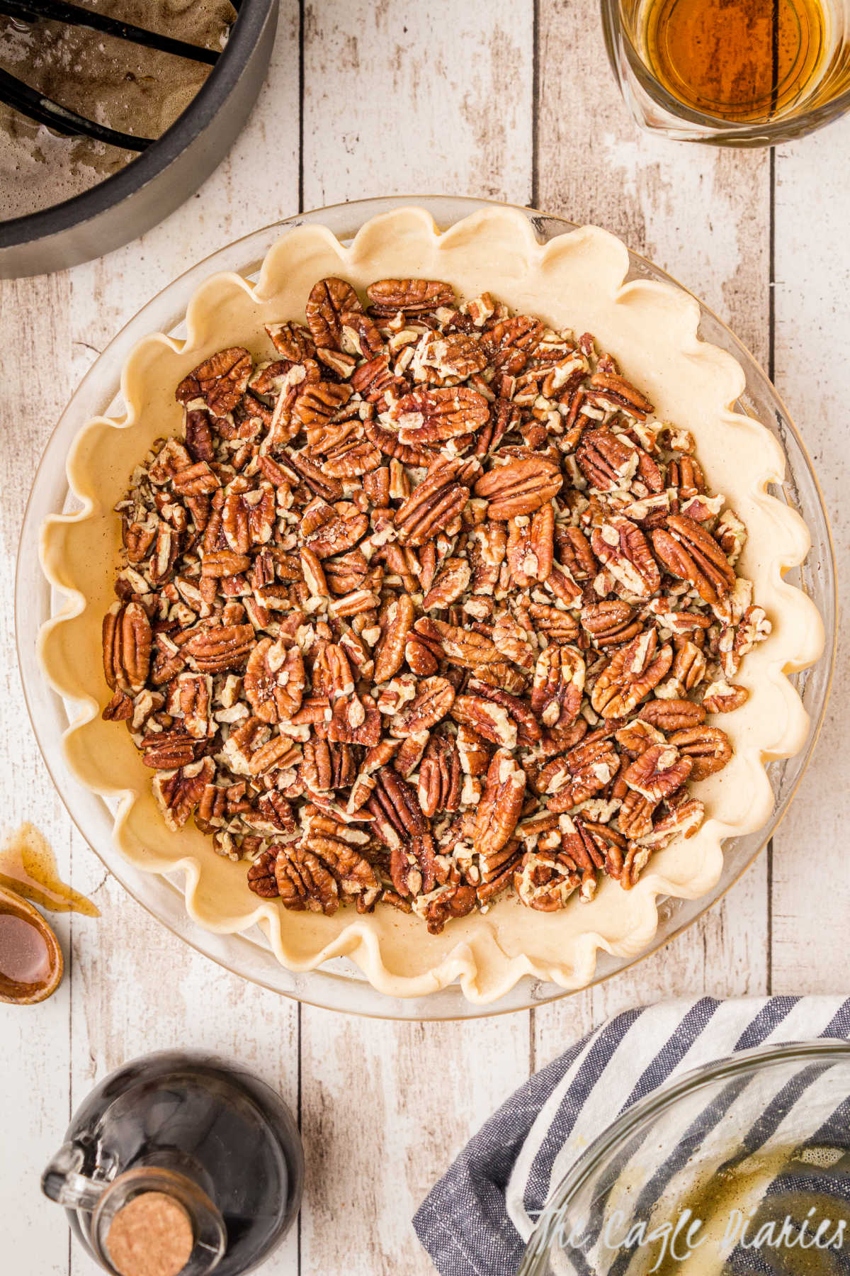 Pecans added to a pie shell.