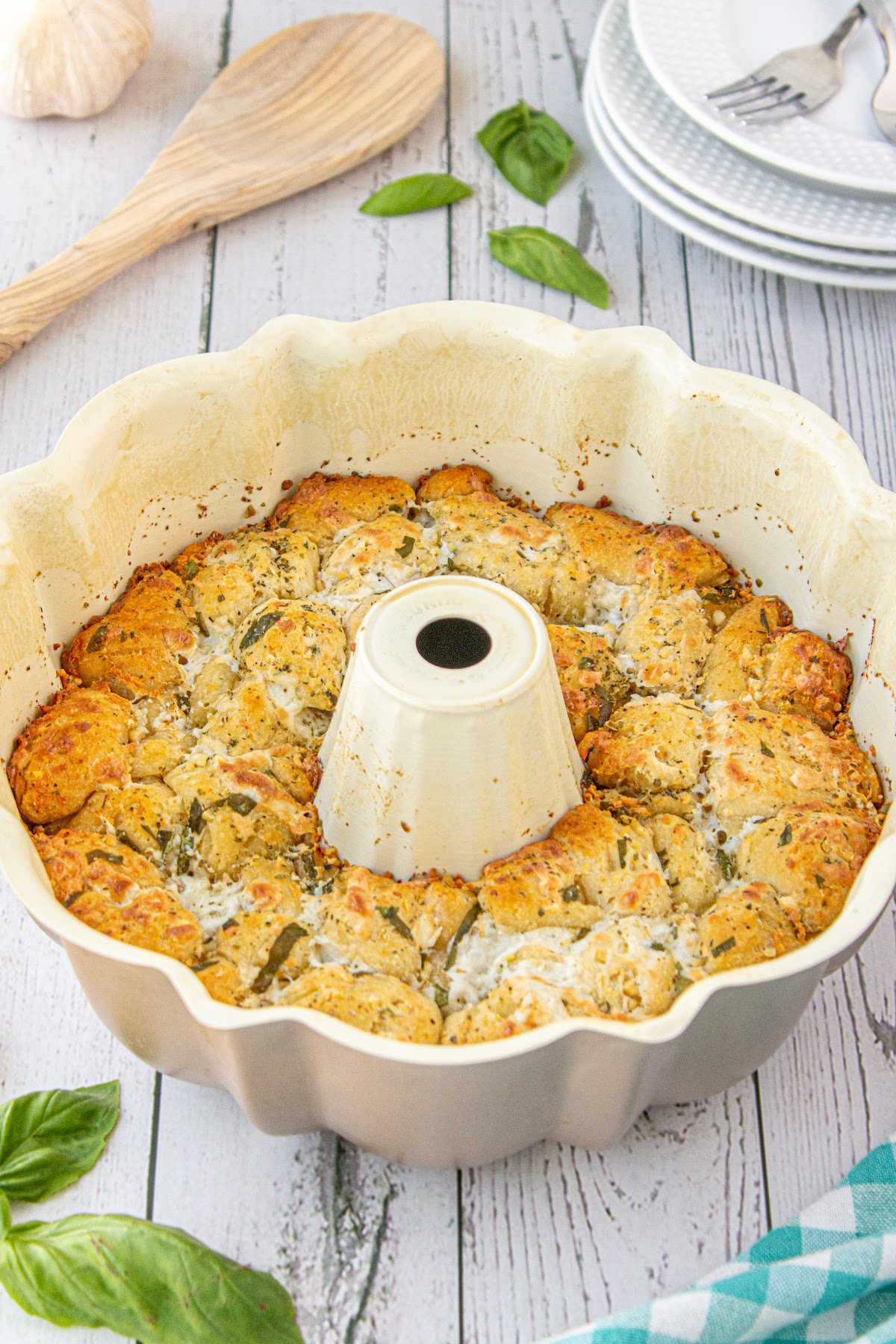 A bundt pan filled with cooked bread and seasonings.