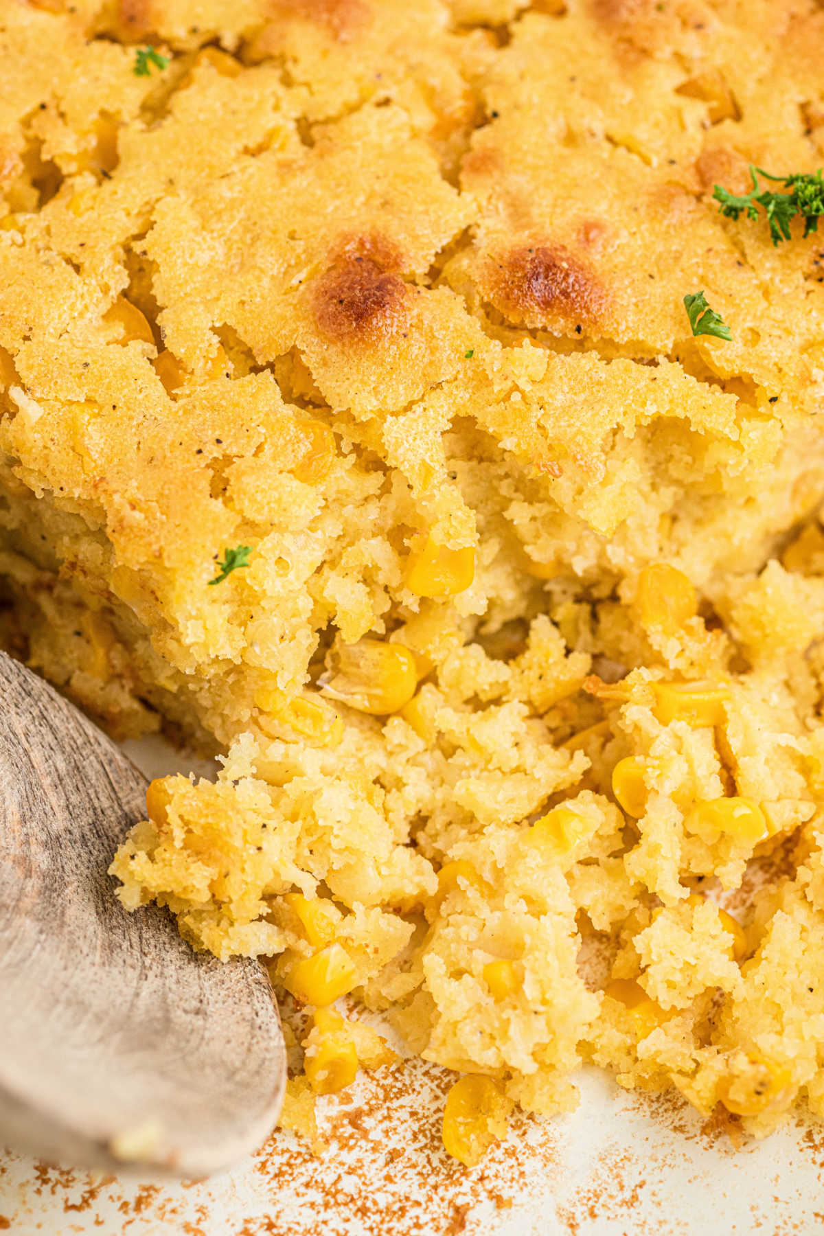 Close up view of a cornbread pudding in a dish.