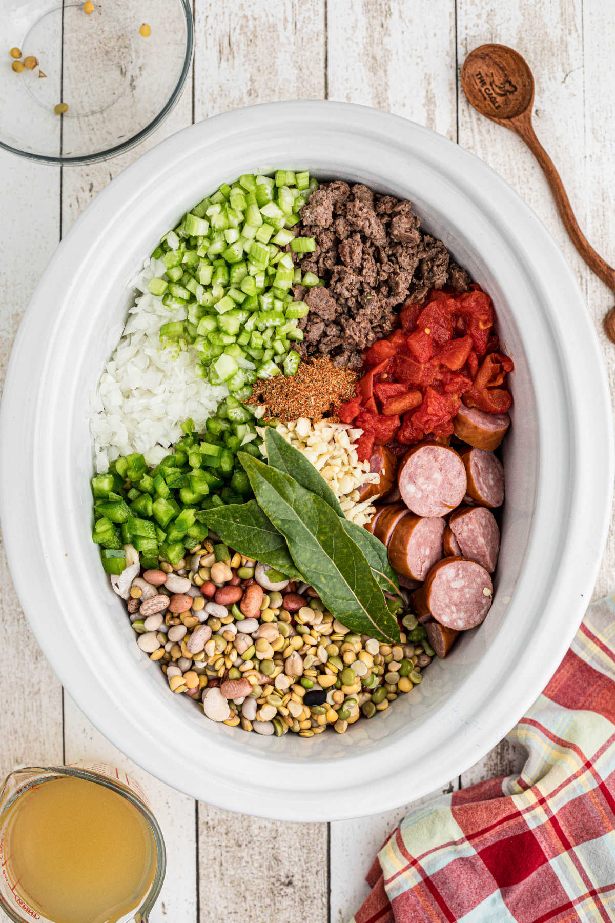 Slow cooker filled with ingredients.