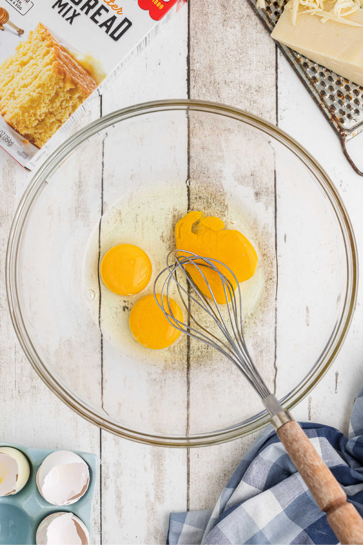 Eggs broken into a mixing bowl, about to be beaten.