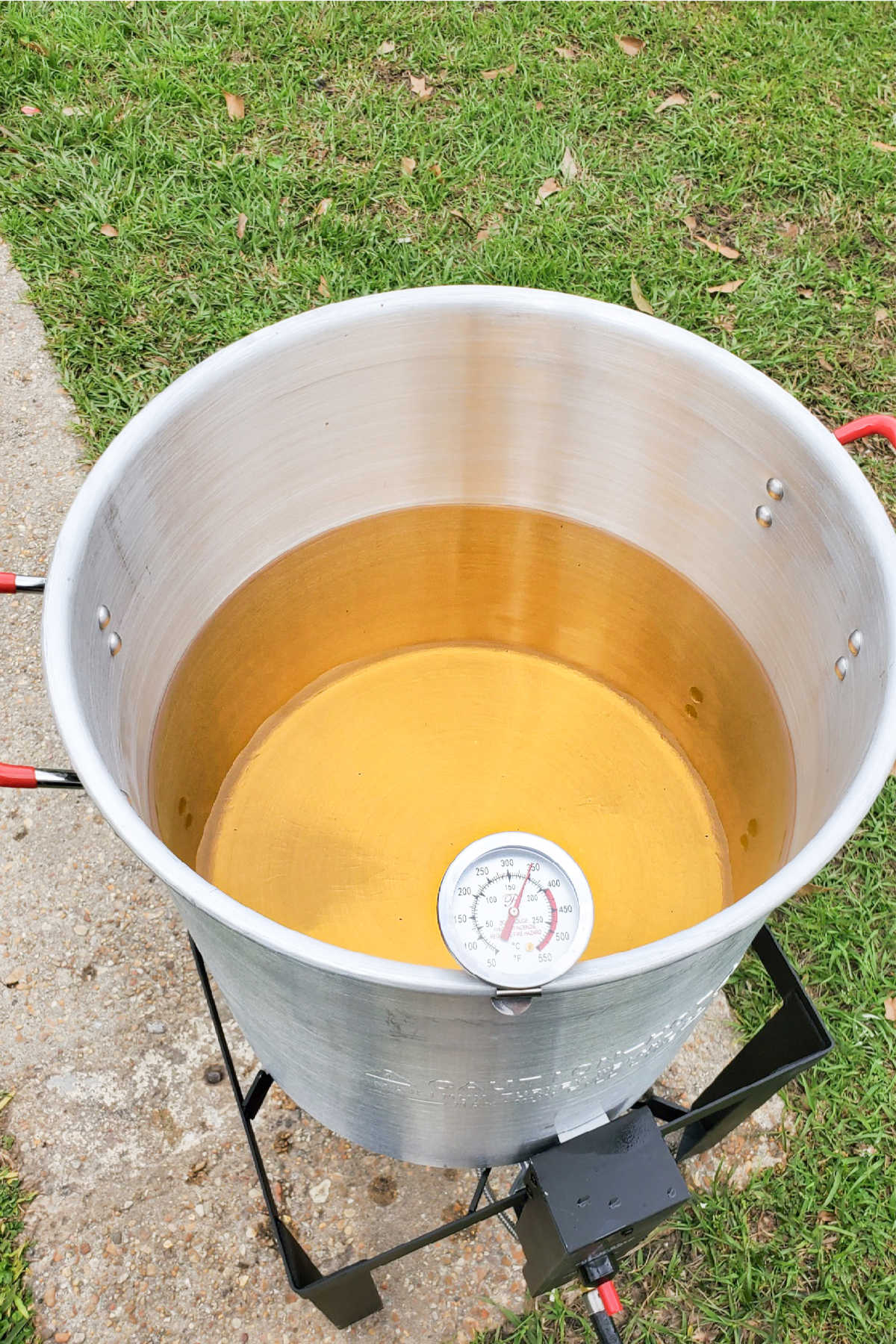 A large frying pot with oil and a thermometer.