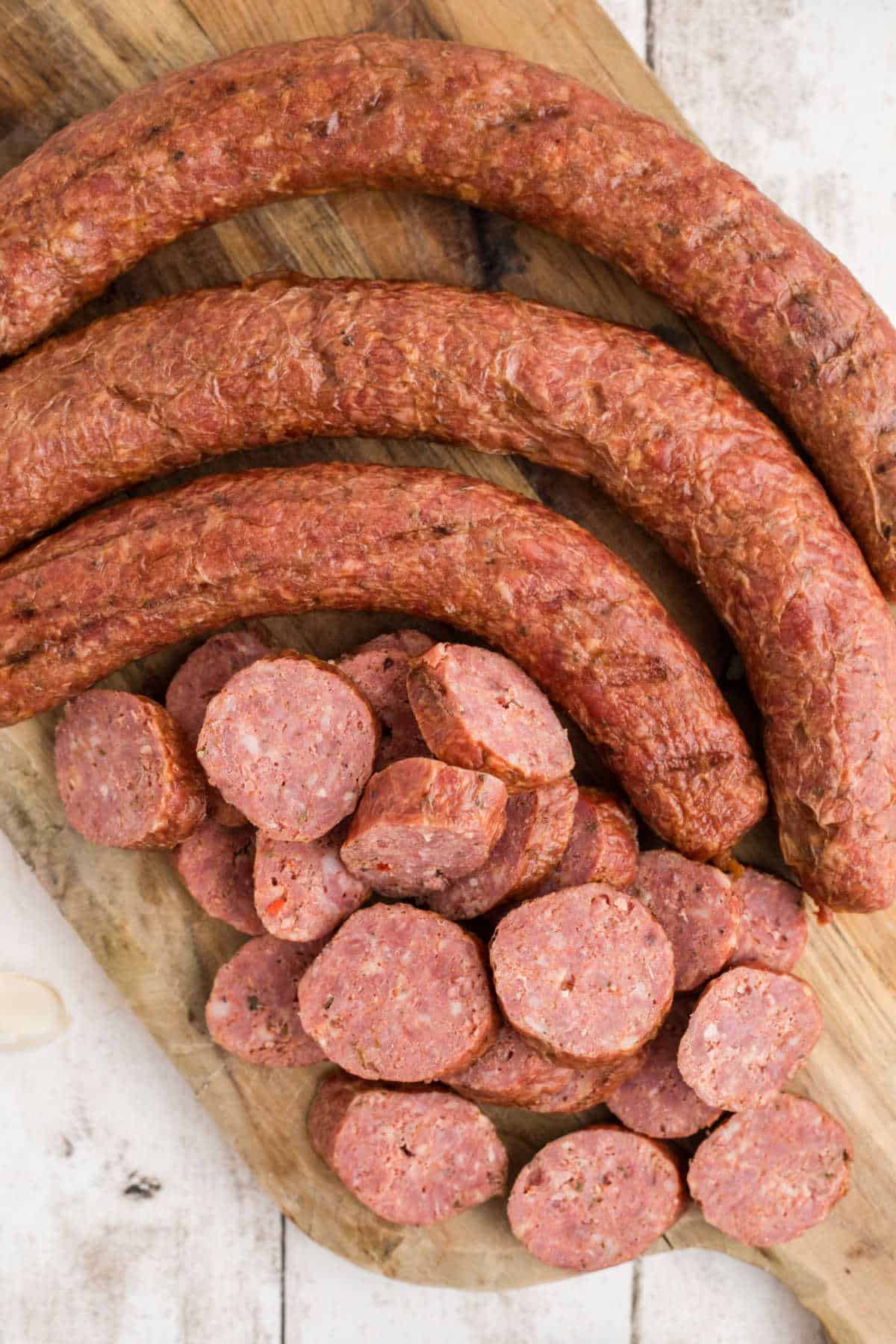 Overhead shot of some andouille sausage, with some sliced into coins.