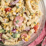 Overhead close up of a bowl of cilantro lime pasta salad, where you can see the rotini pasta.