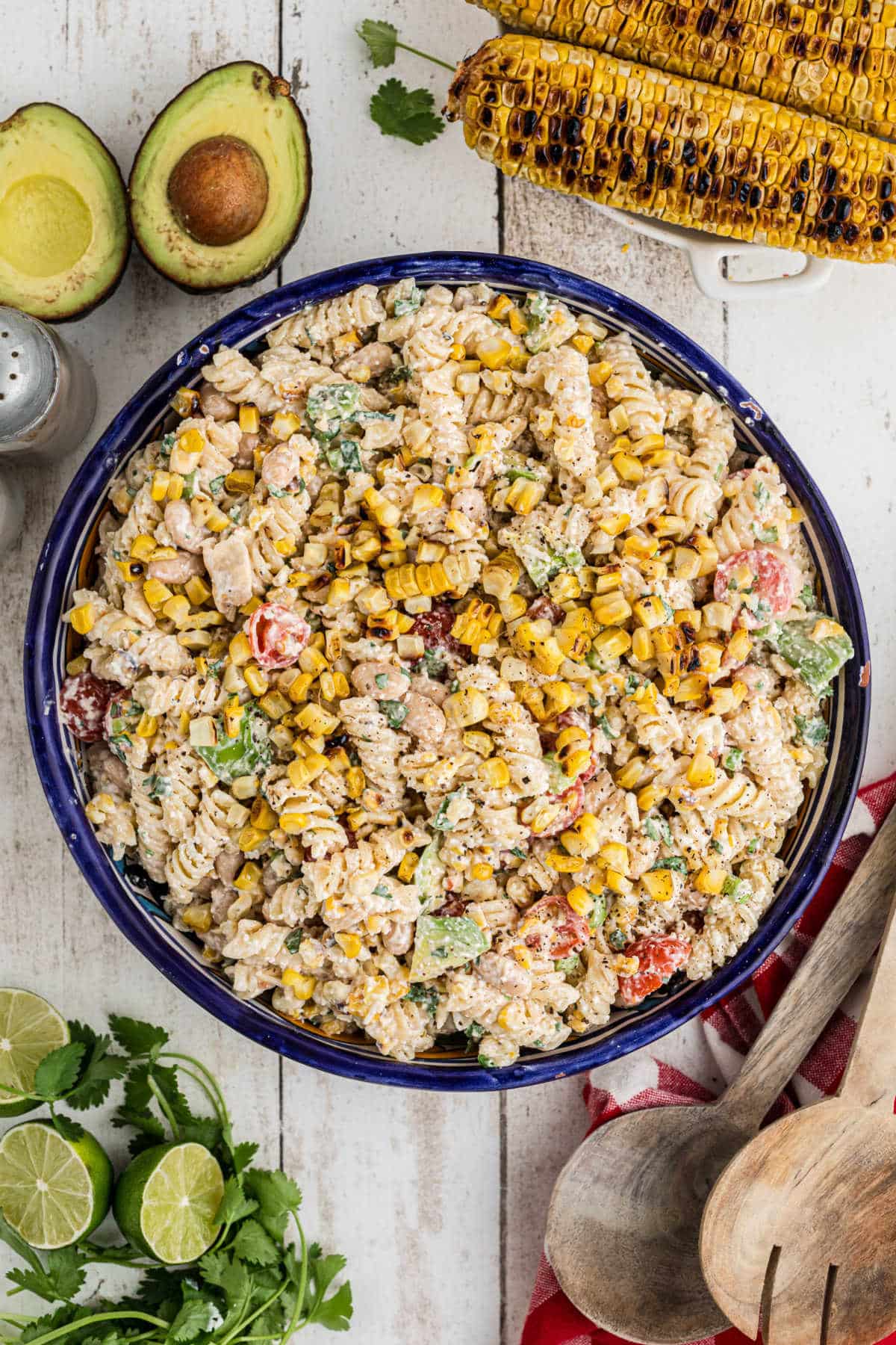 Overhead shot of a bowl of Elotes pasta salad with some grilled corn in the background.