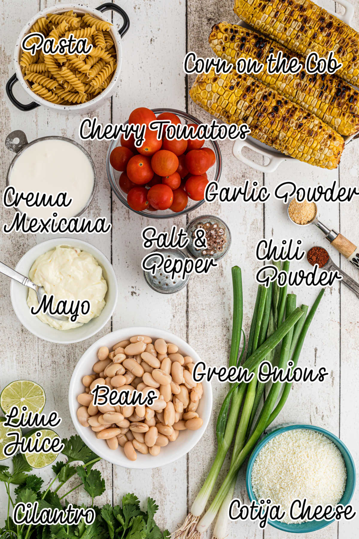Overhead shot of ingredients needed to make Elotes pasta salad with text overlay.
