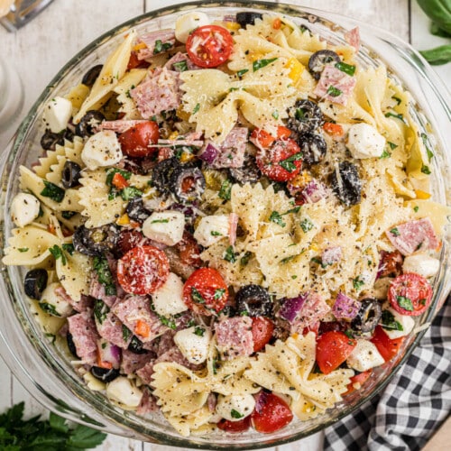 An overhead image of a bowl of Italian Pasta Salad, with seasoning grated on top.