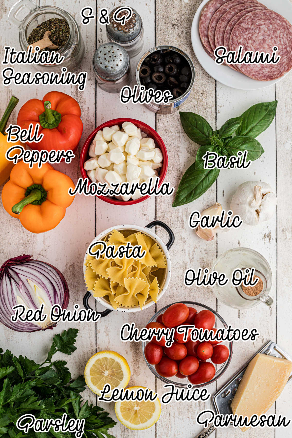 An overhead image of ingredients needed to make an Italian pasta salad, with text overlay.