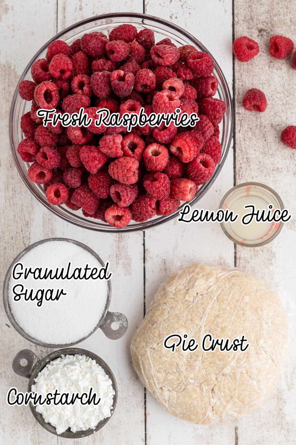 Overhead shot of ingredients needed to make a raspberry pie, with text overlay.