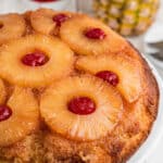 Close up image from the side of a pineapple upside down cake.