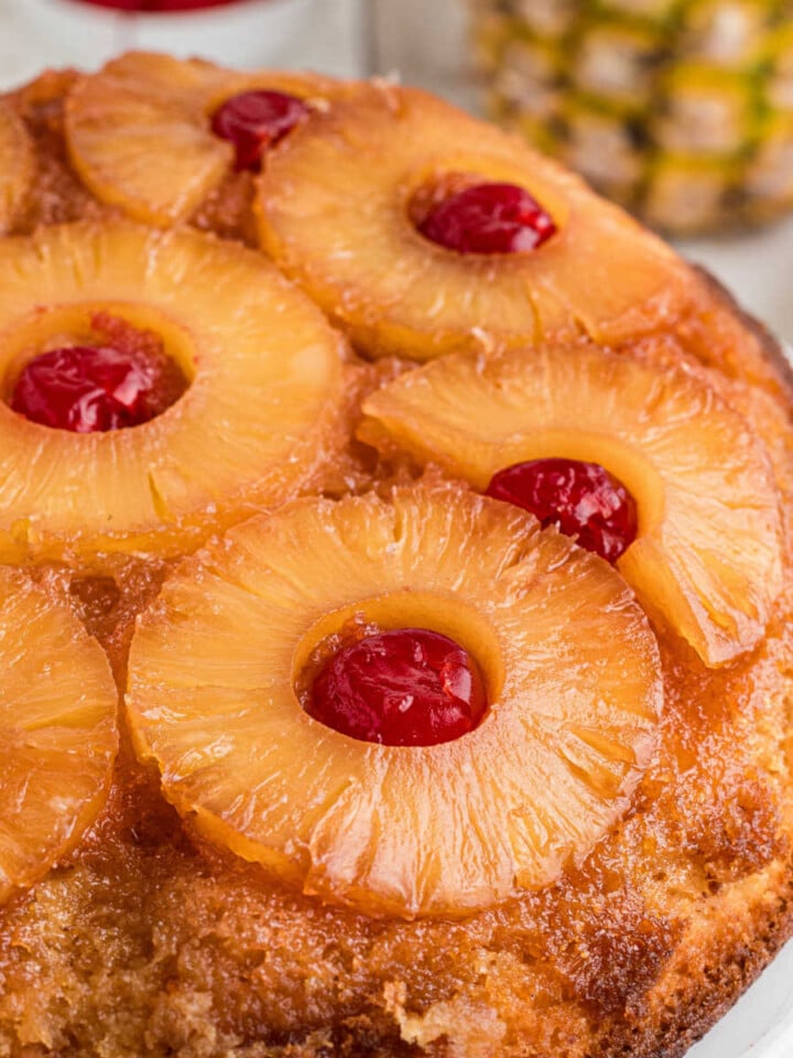 Close up image from the side of a pineapple upside down cake.