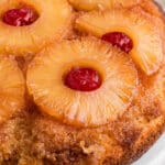 Close up side on image of a pineapple upside down cake with text overlay for pinterest.